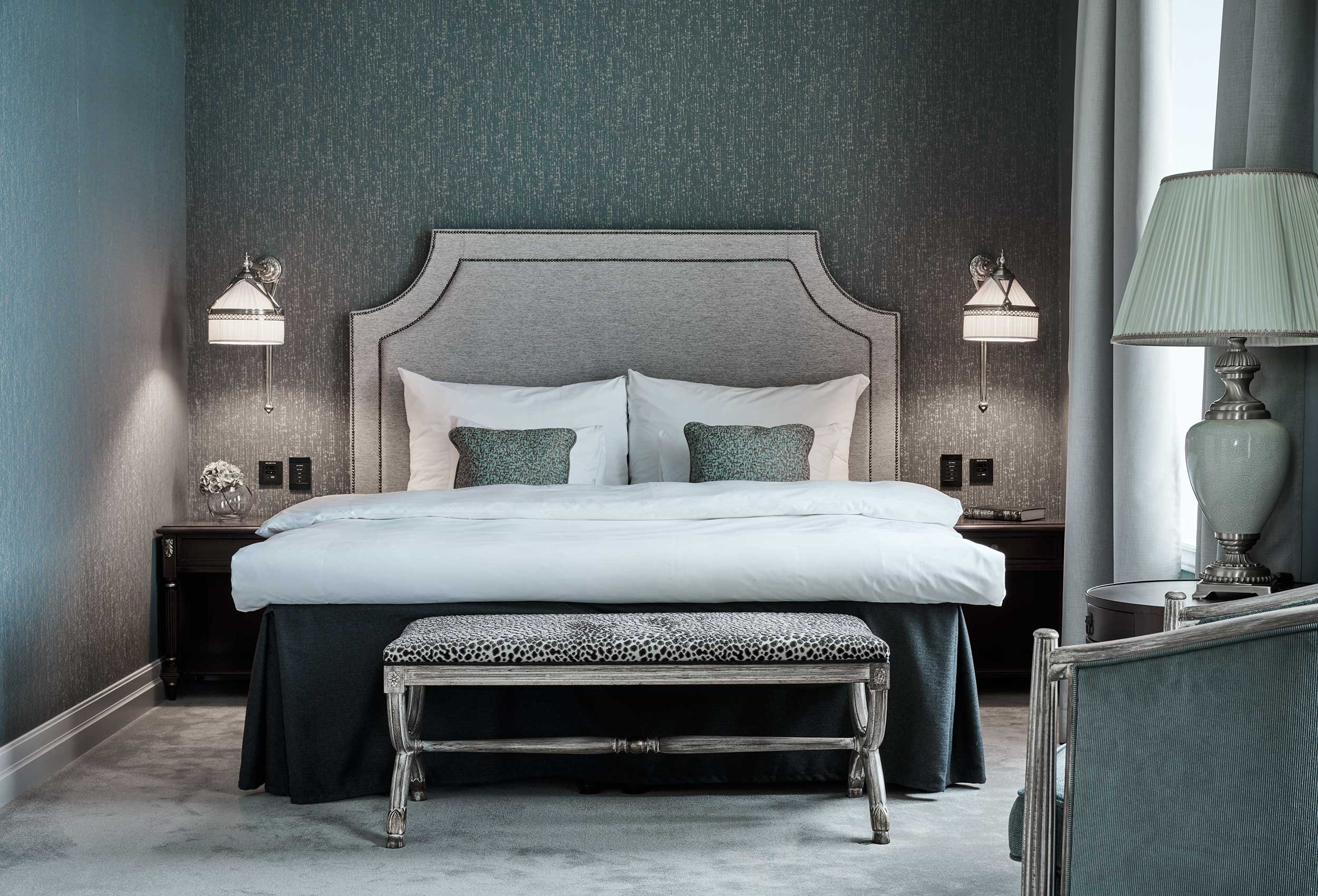 king size hotel bed with bed linen with monogram logo in a luxury hotel with beautiful view Hotel Victoria