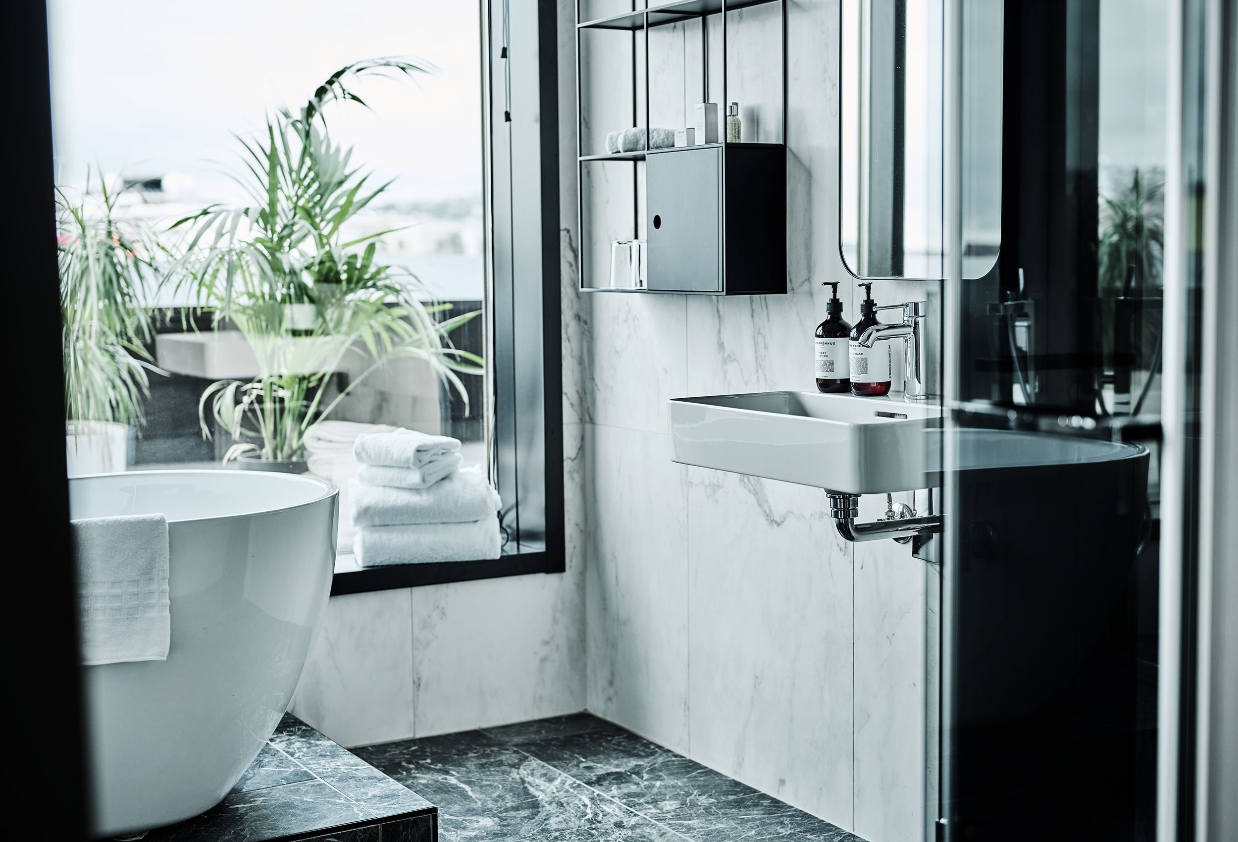Modern luxury bathroom with bathtub and beautiful view of the sea