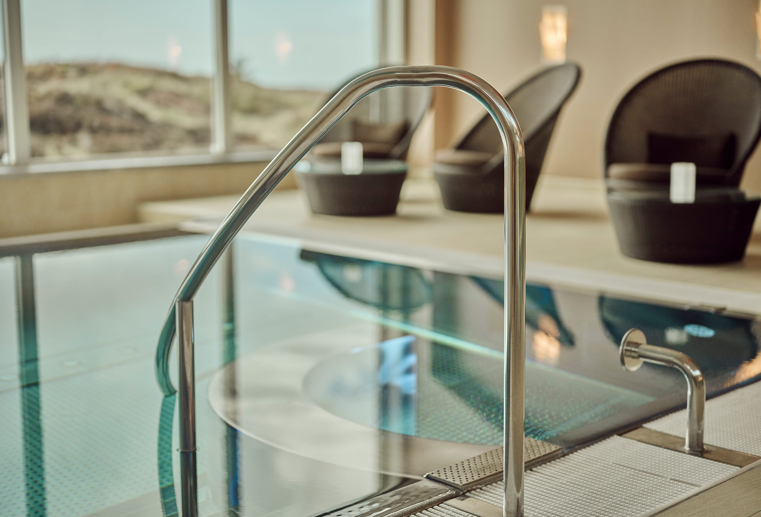Close-up of swimming pool with lovely mirrored water and sea view