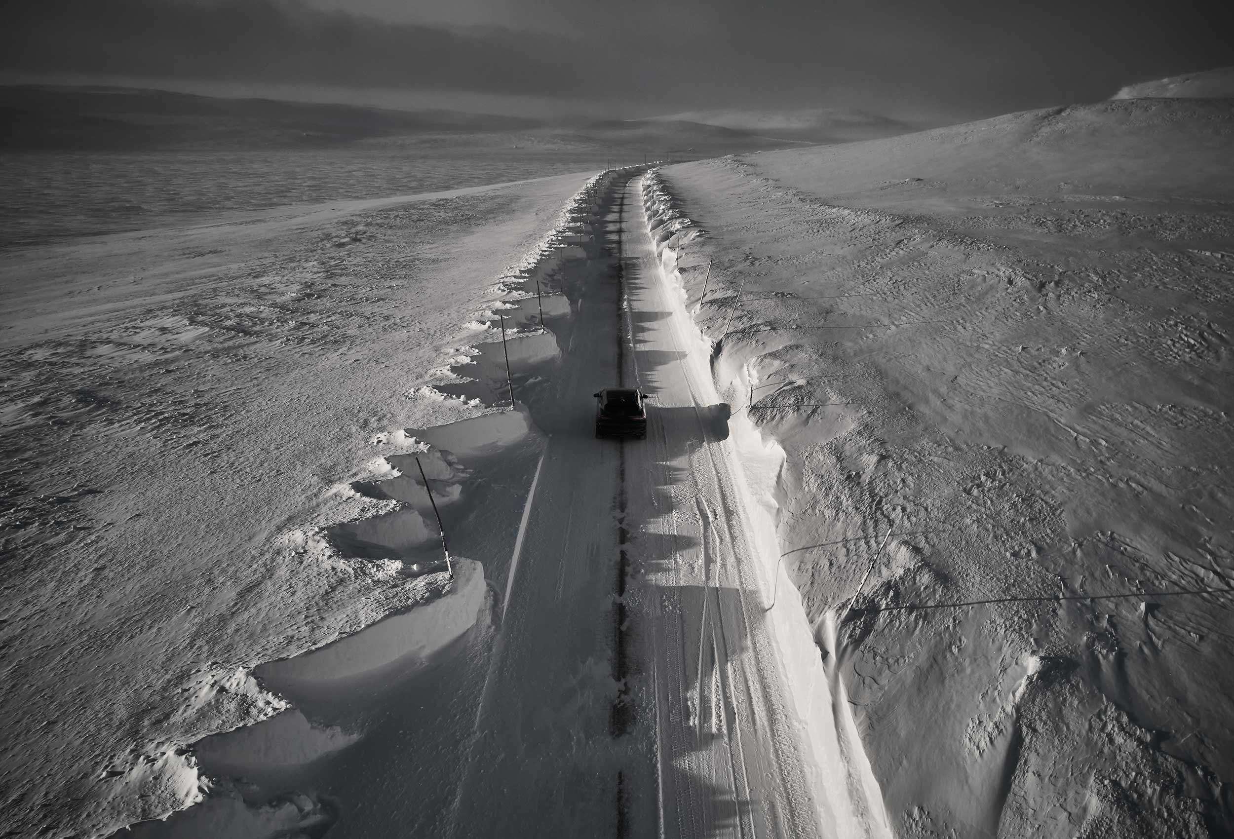 Jaguar I-PACE Land Rover in snow landscape. Car photography and drone video in Norway