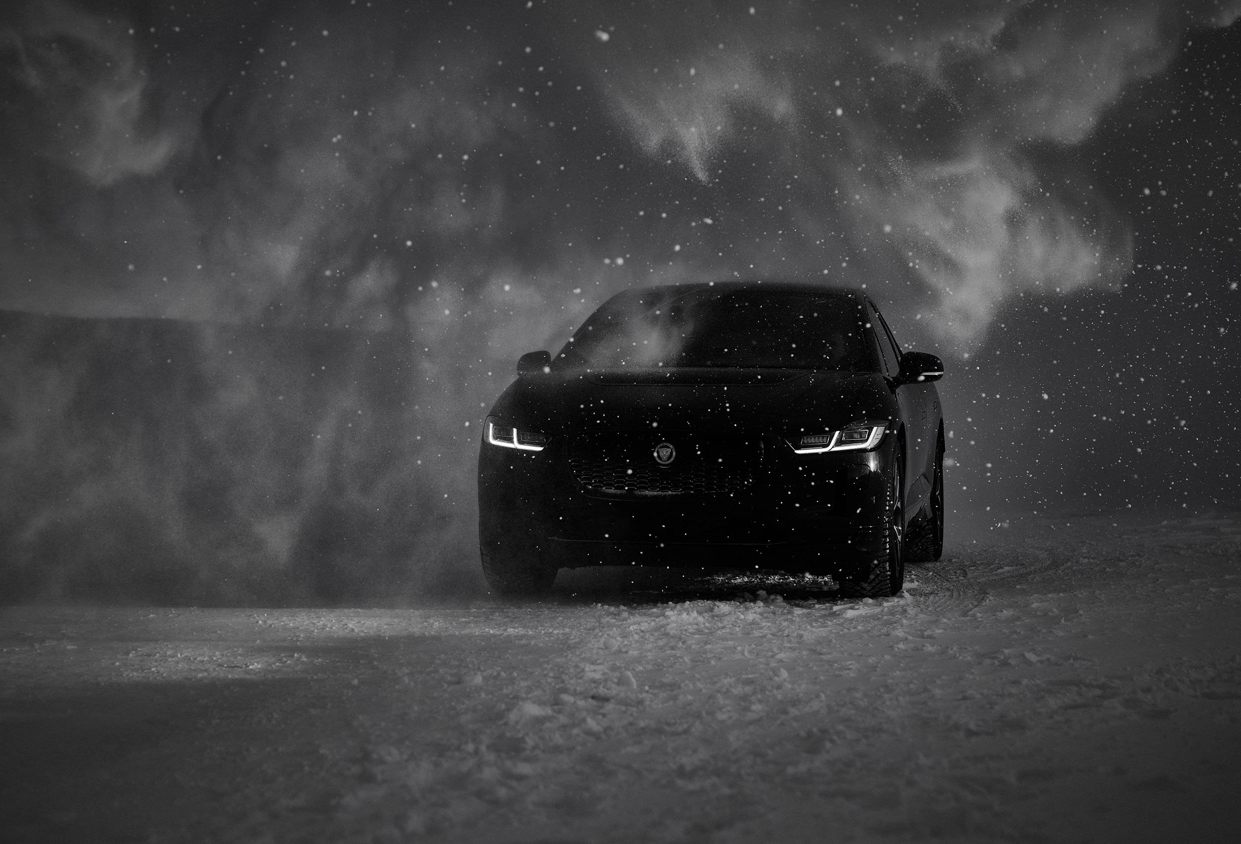 Jaguar I-PACE Land Rover in snow landscape. Car photography and drone video in Norway