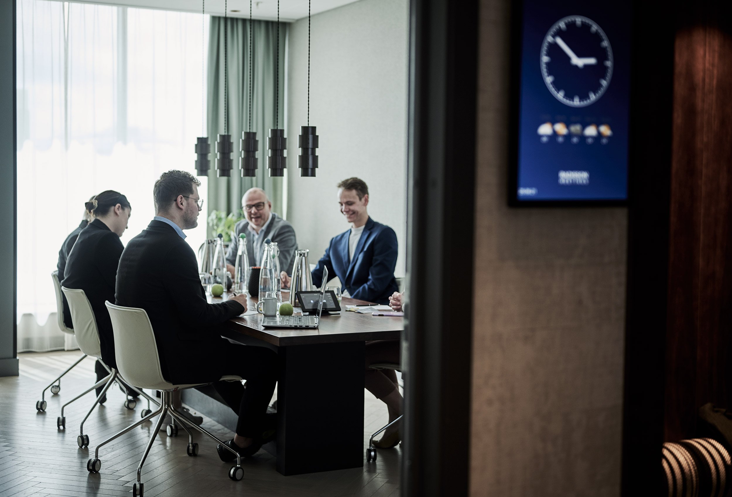 Mood picture from a meeting room with windows and pleasant light at the Radisson Blu Caledonien Hotel, Kristiansand with smiling colleagues