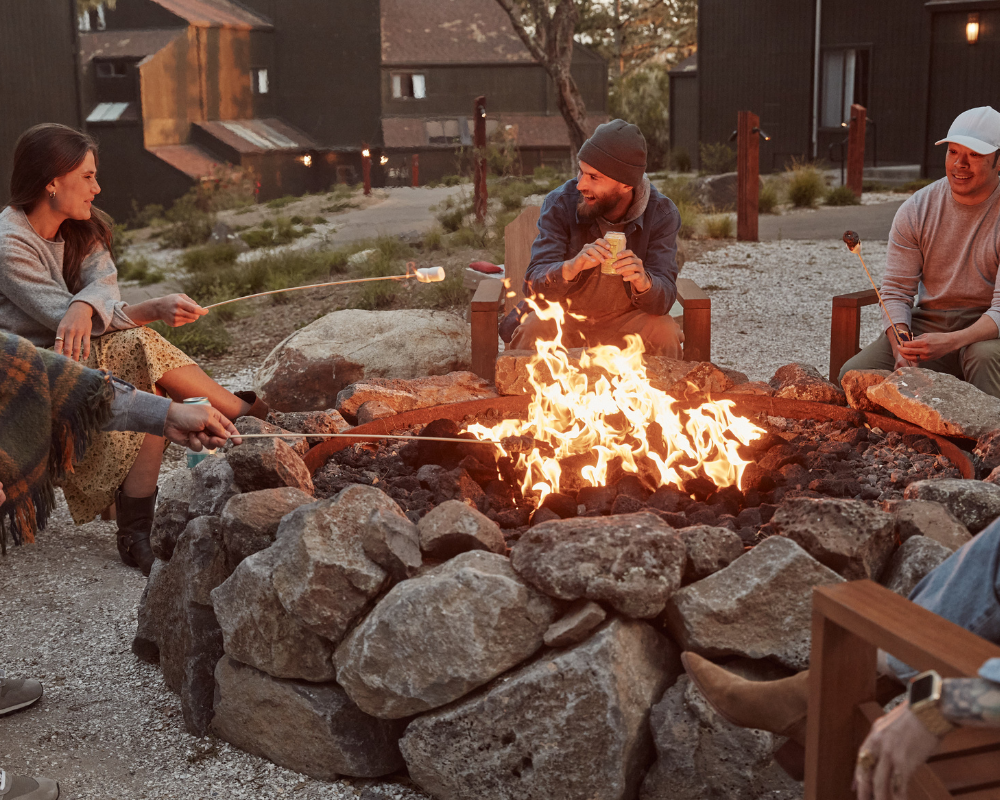 colleagues around firepit making smores