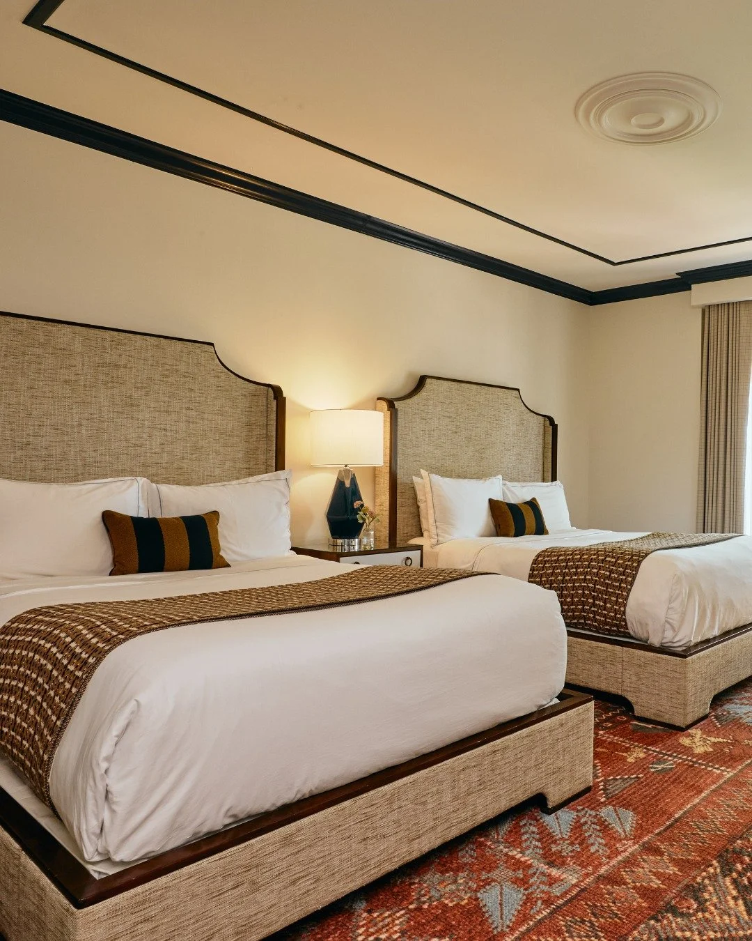 Two queens, one very good reason to stay in. 
 
Luxe linens, quiet light, and space to unwind side by side.