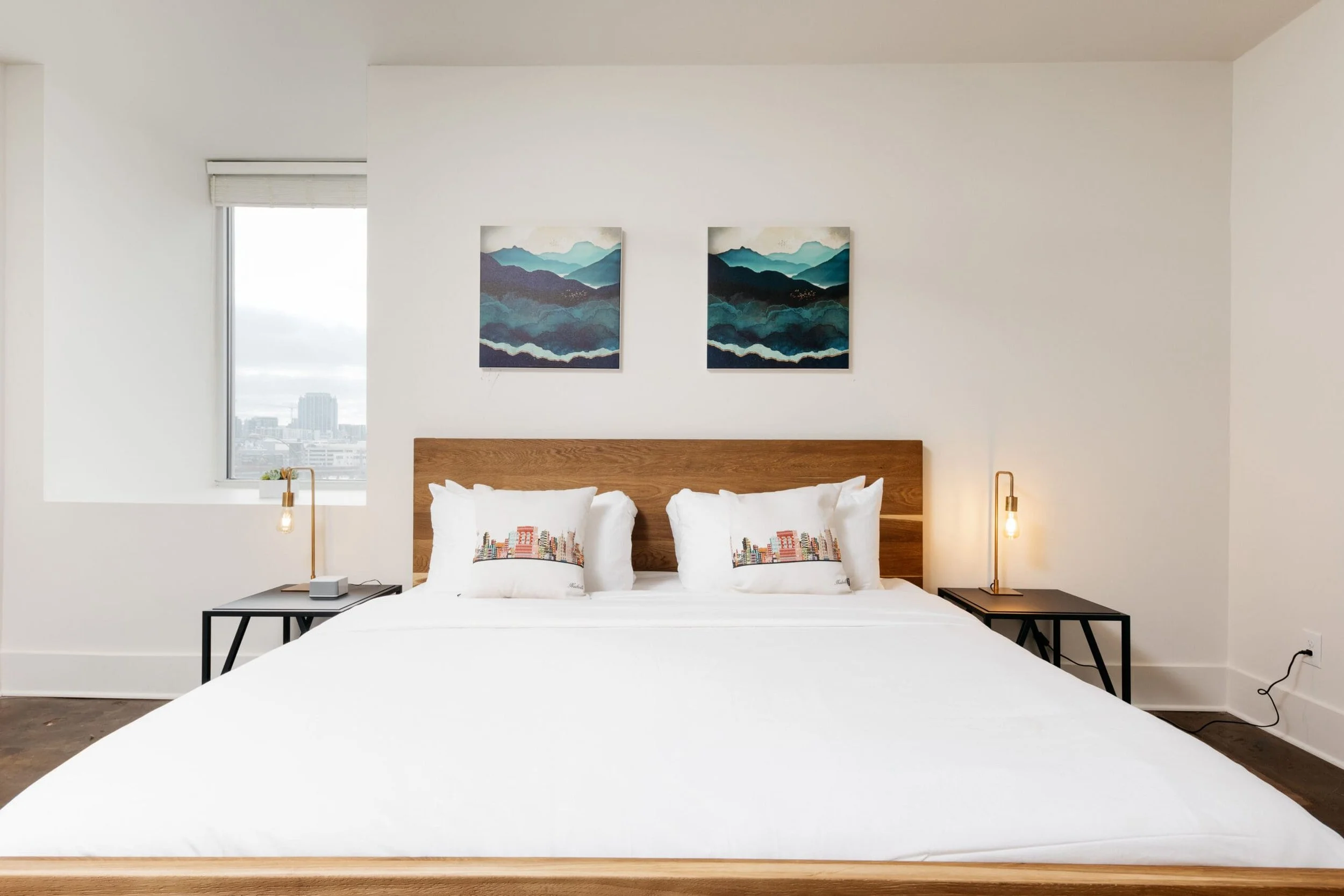 Bed with two paintings over it