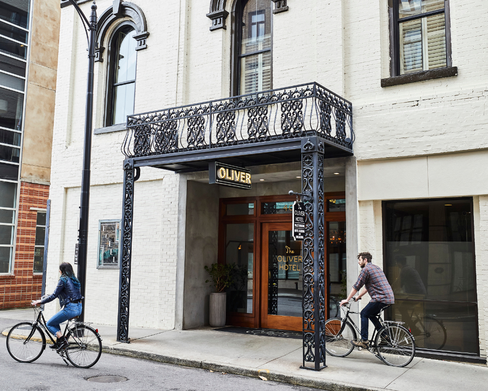 people riding bikes outside hotel