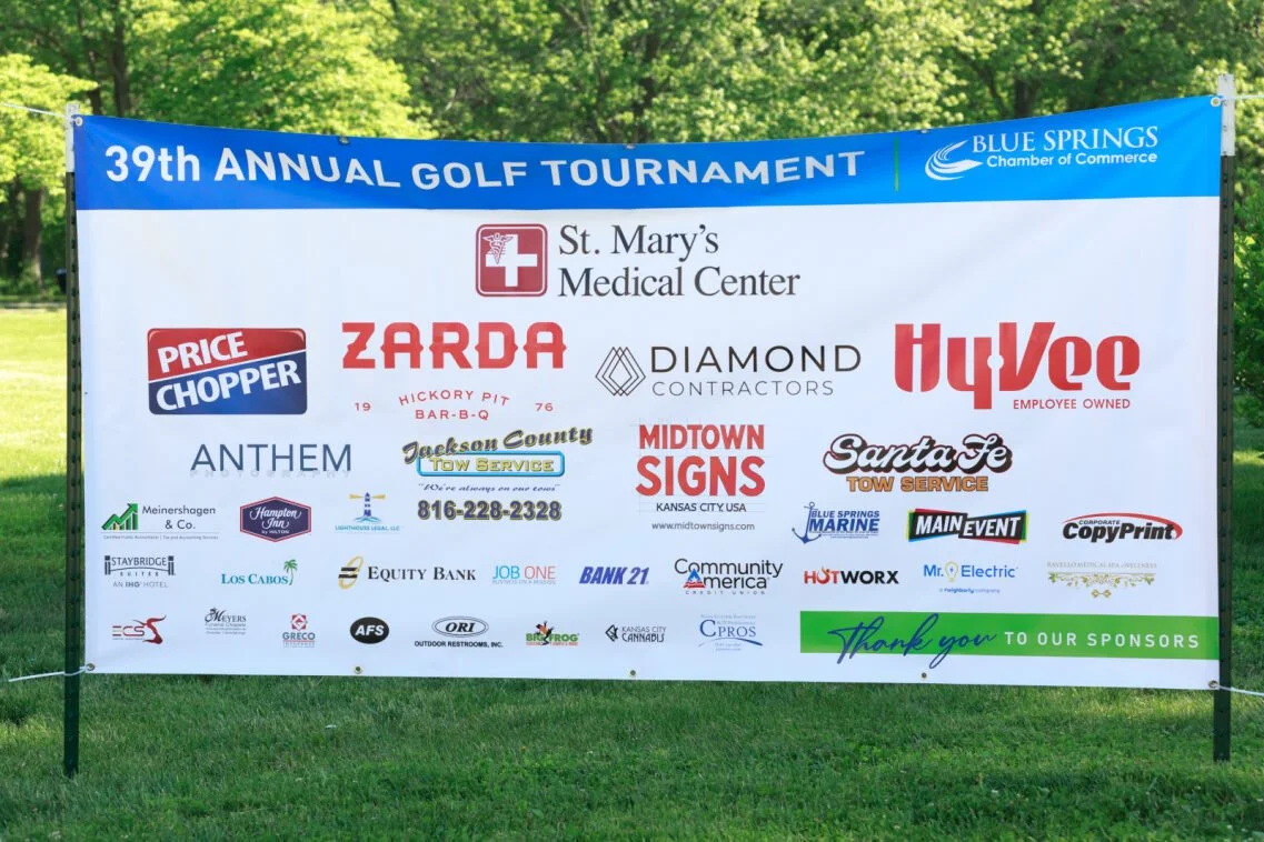 Large banner with logos of businesses that sponsored a golf tournament