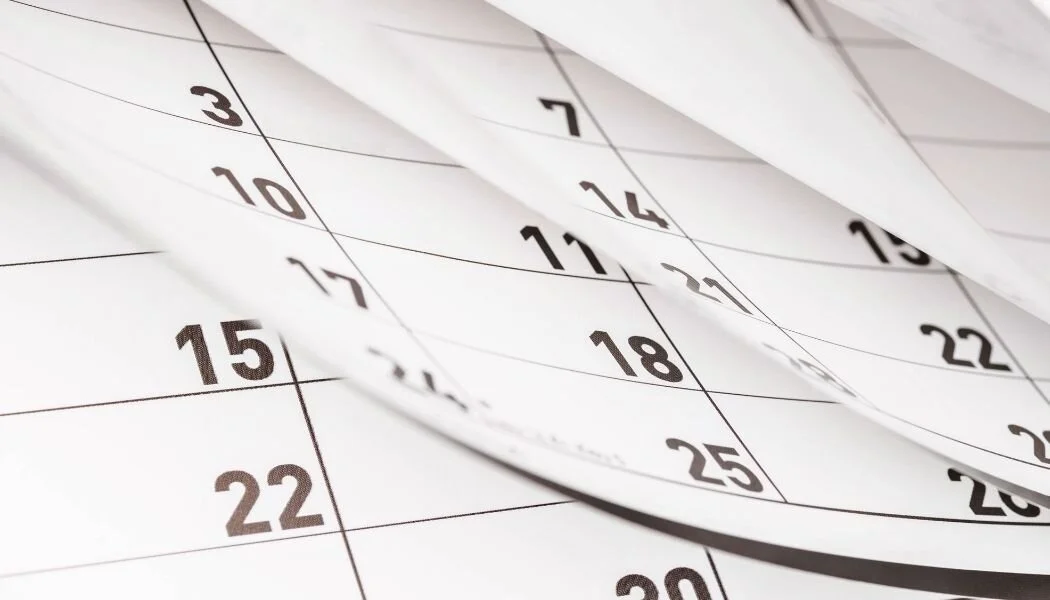 Close-up of calendar pages with numbers, showing dates.