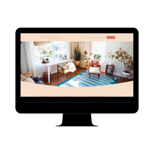 Living room with large windows, white desk, chair, and various potted plants; blue and white patterned rug on wooden floor.