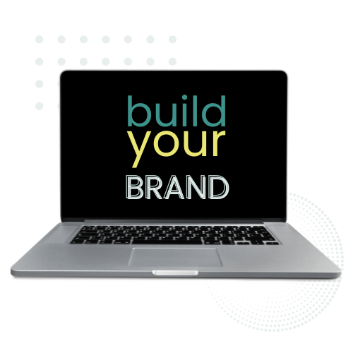 Laptop displaying text 'build your BRAND' on the screen.