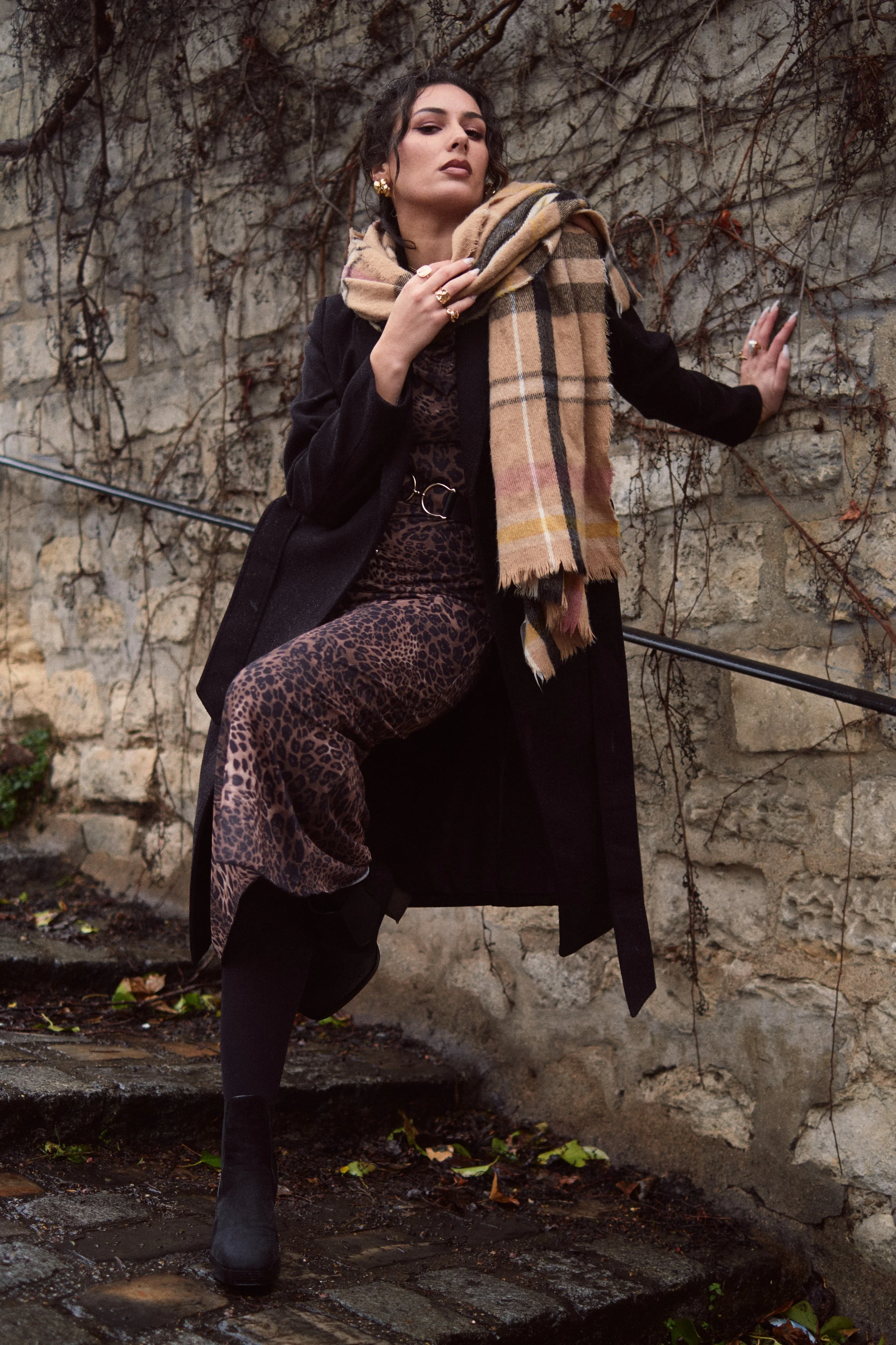 Photo of woman in Montmartre, Paris. Photograph by Owen Clarke. Woman is wearing a long black coat, purple dress and a beige patterned scarf