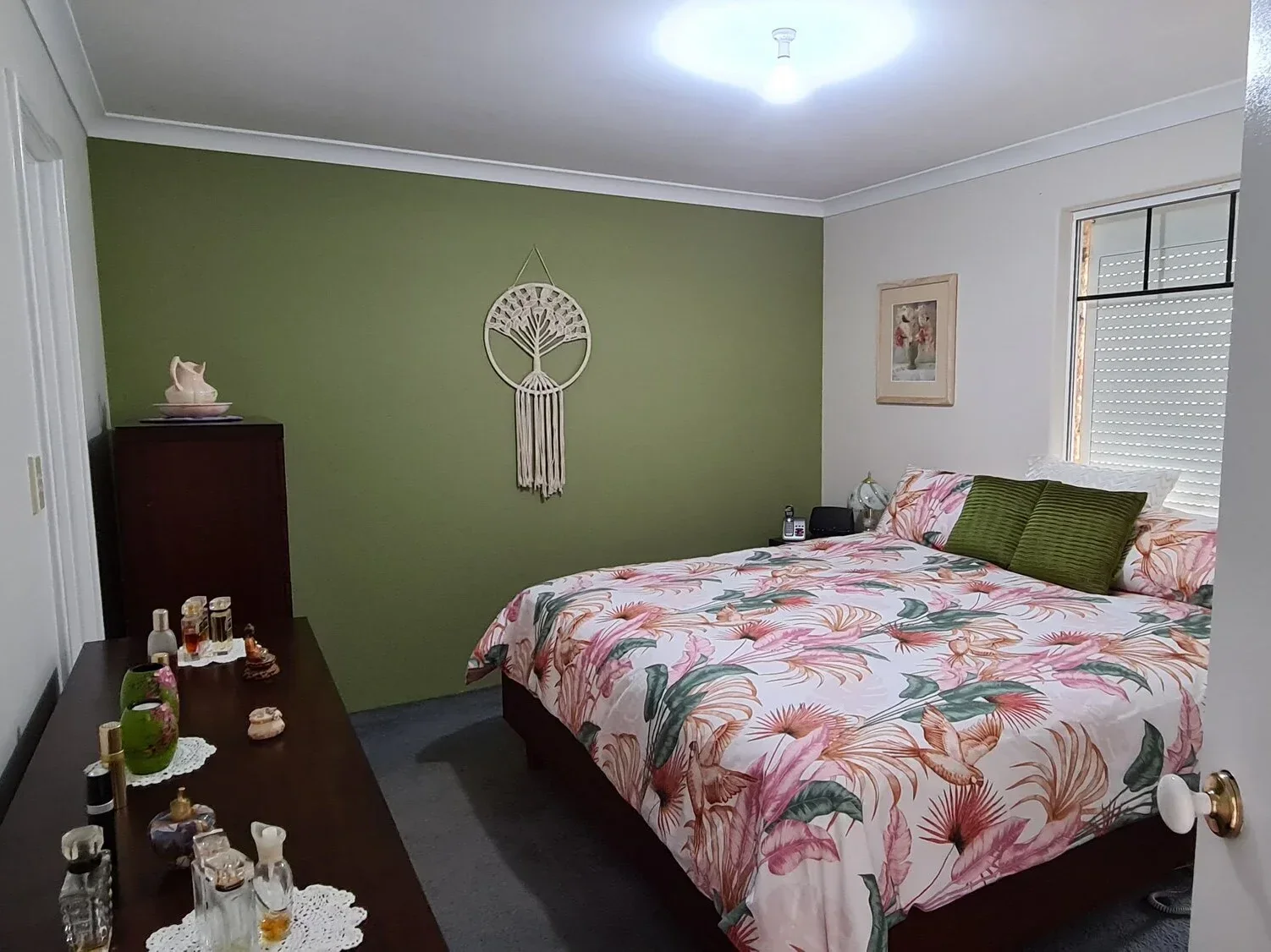 Master bedroom interior painting in Perth featuring a smooth olive green accent wall with crisp white cornices and ceiling.