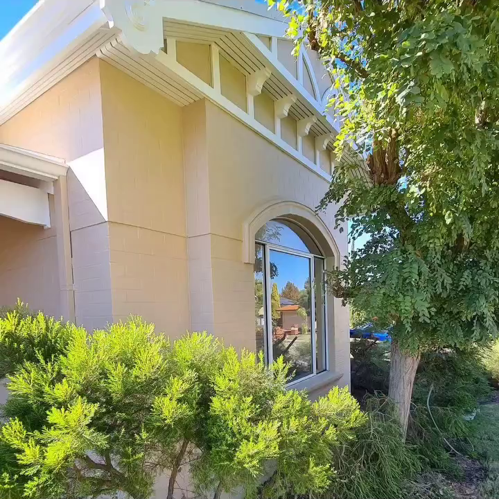 Close-up of a decorative arched window and white timber gables painted by professional house painters in Canning Vale.