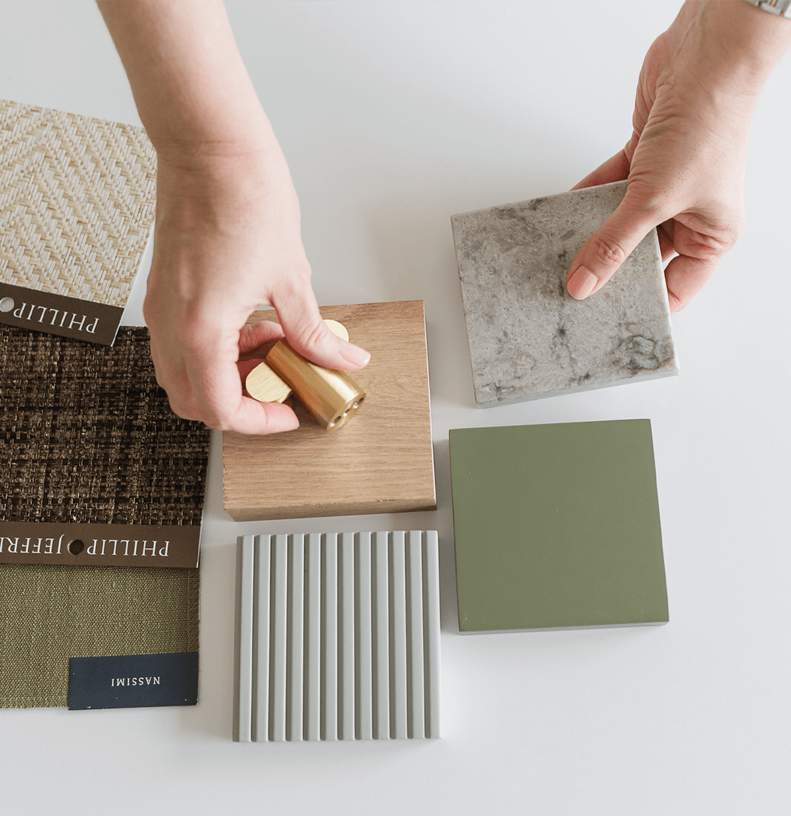 interior designers hand arranging material samples