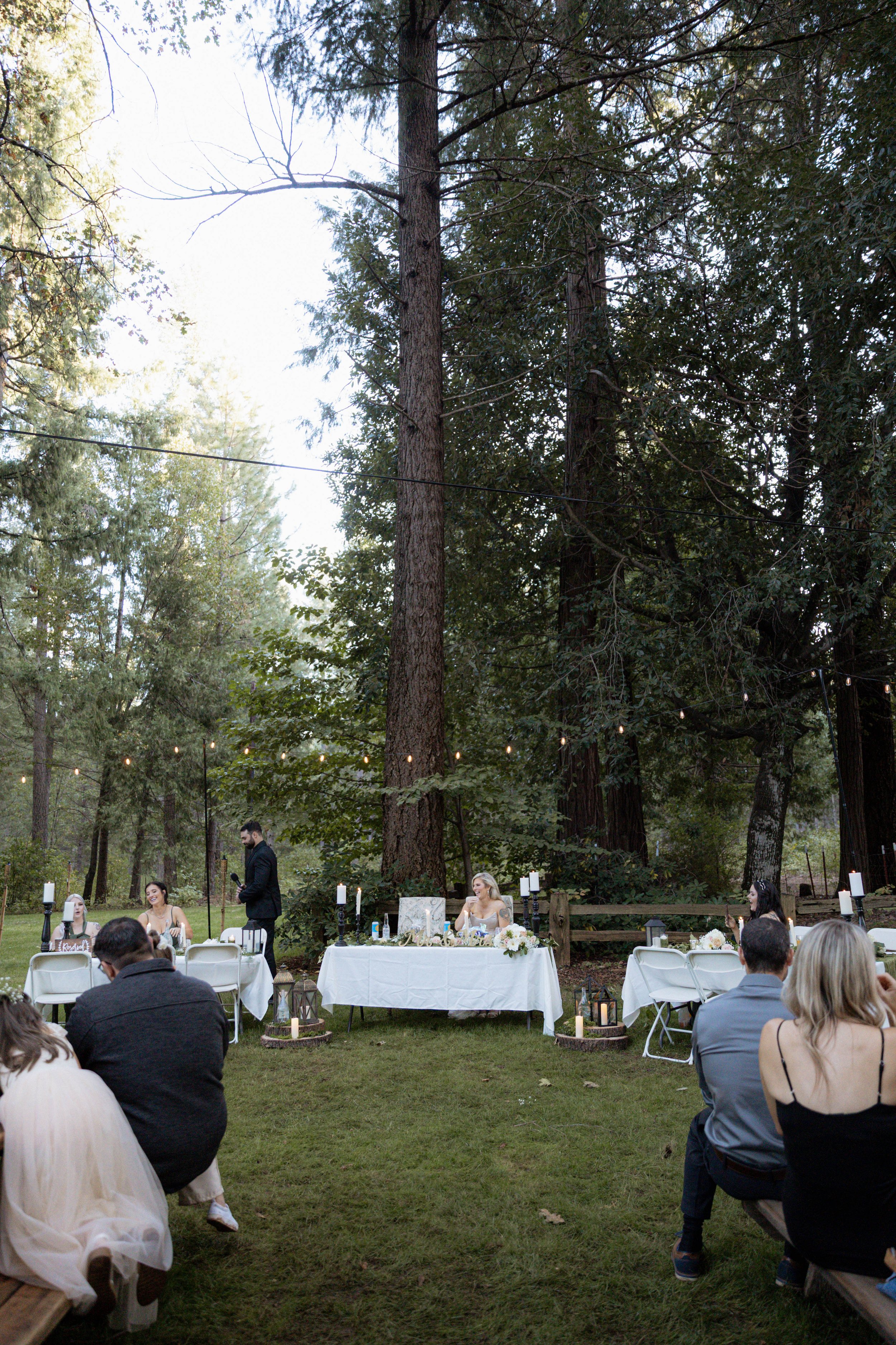 A couple sitting at the sweetheart table at their California wedding venue