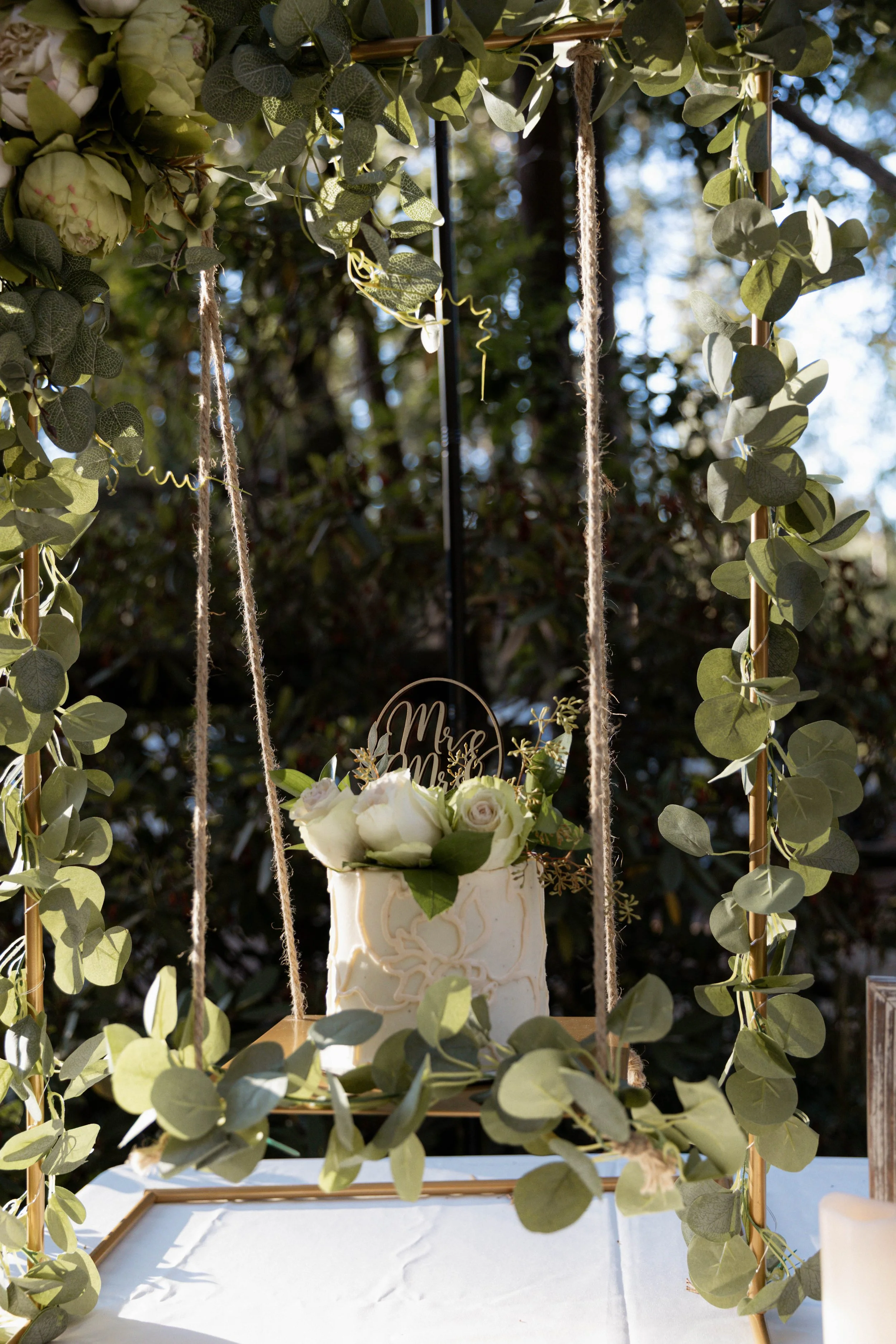 A wedding cake with a Mr. and Mrs. cake topper