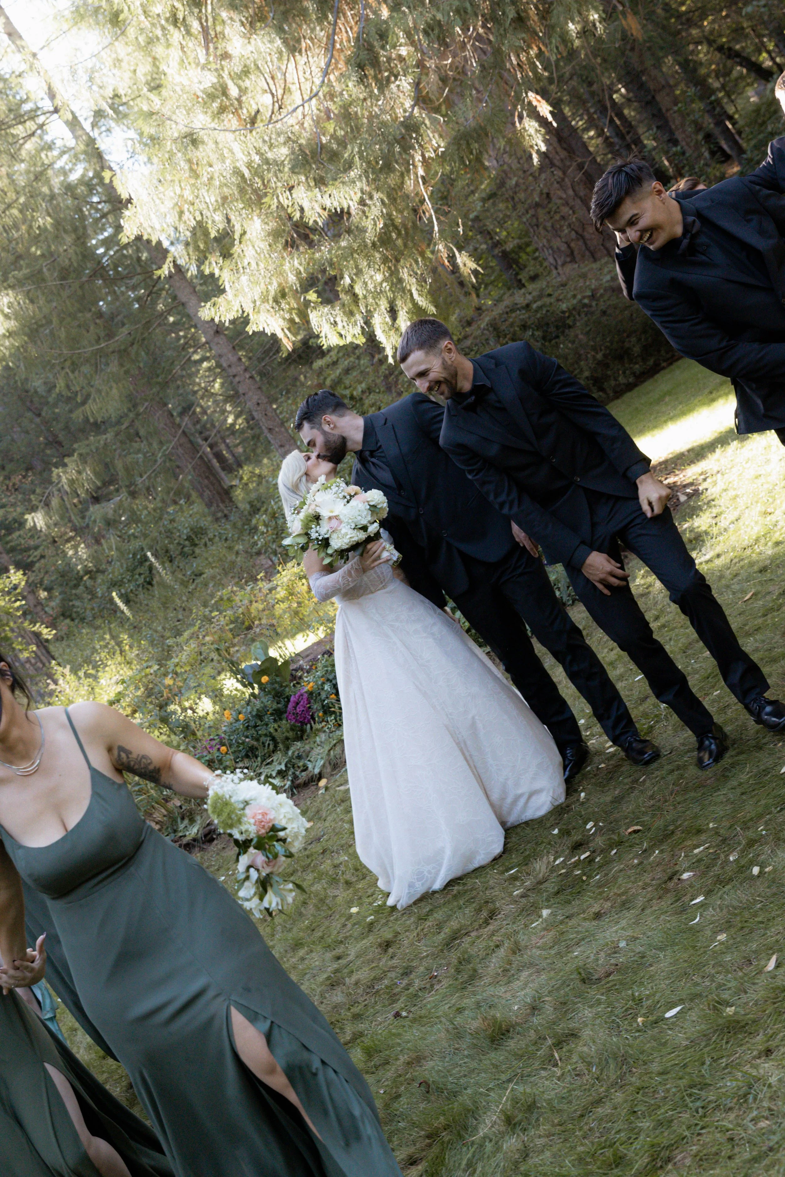 A bride and groom kissing walking away from their wedding ceremony