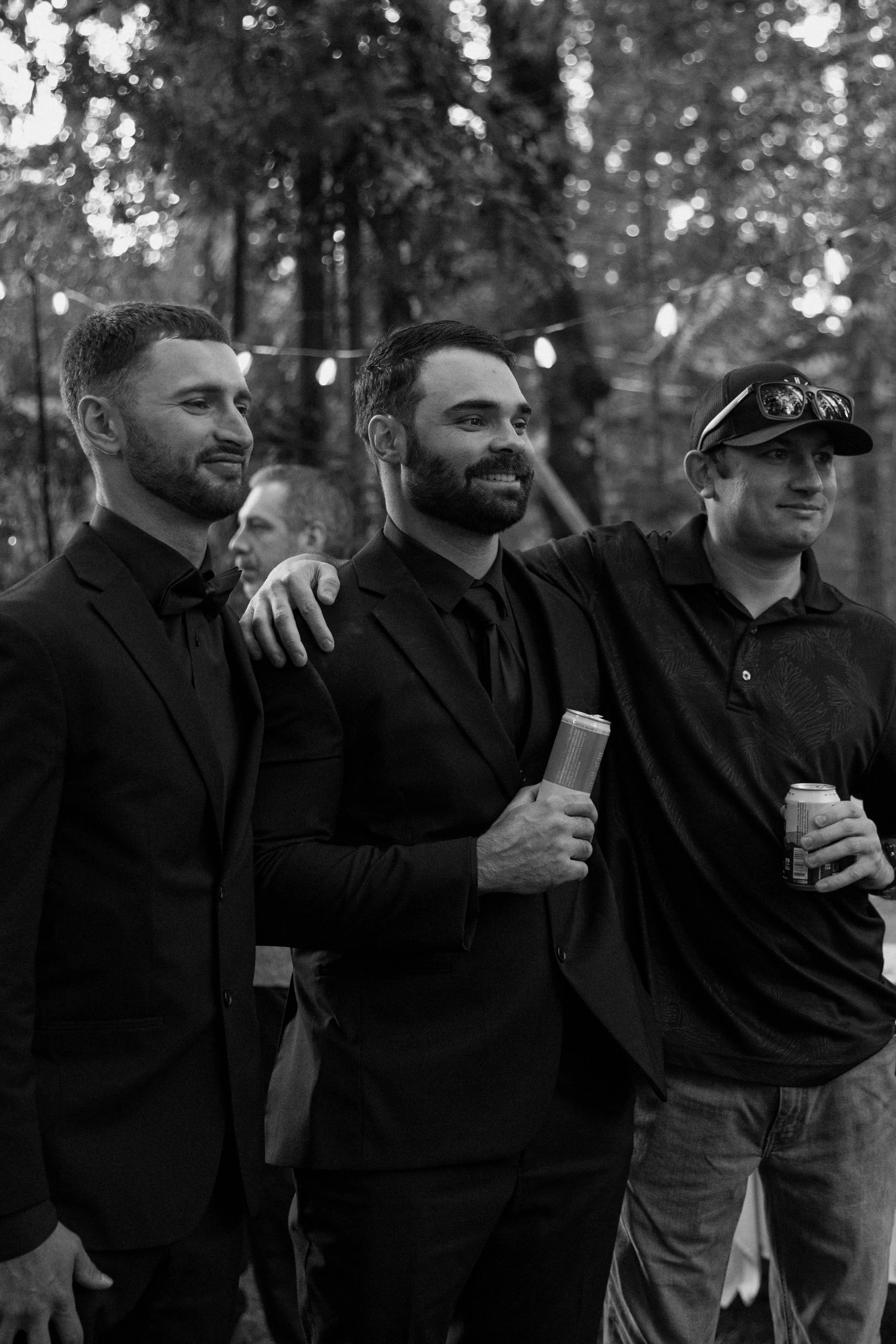 A groom standing with his groomsmen in a candid wedding photo