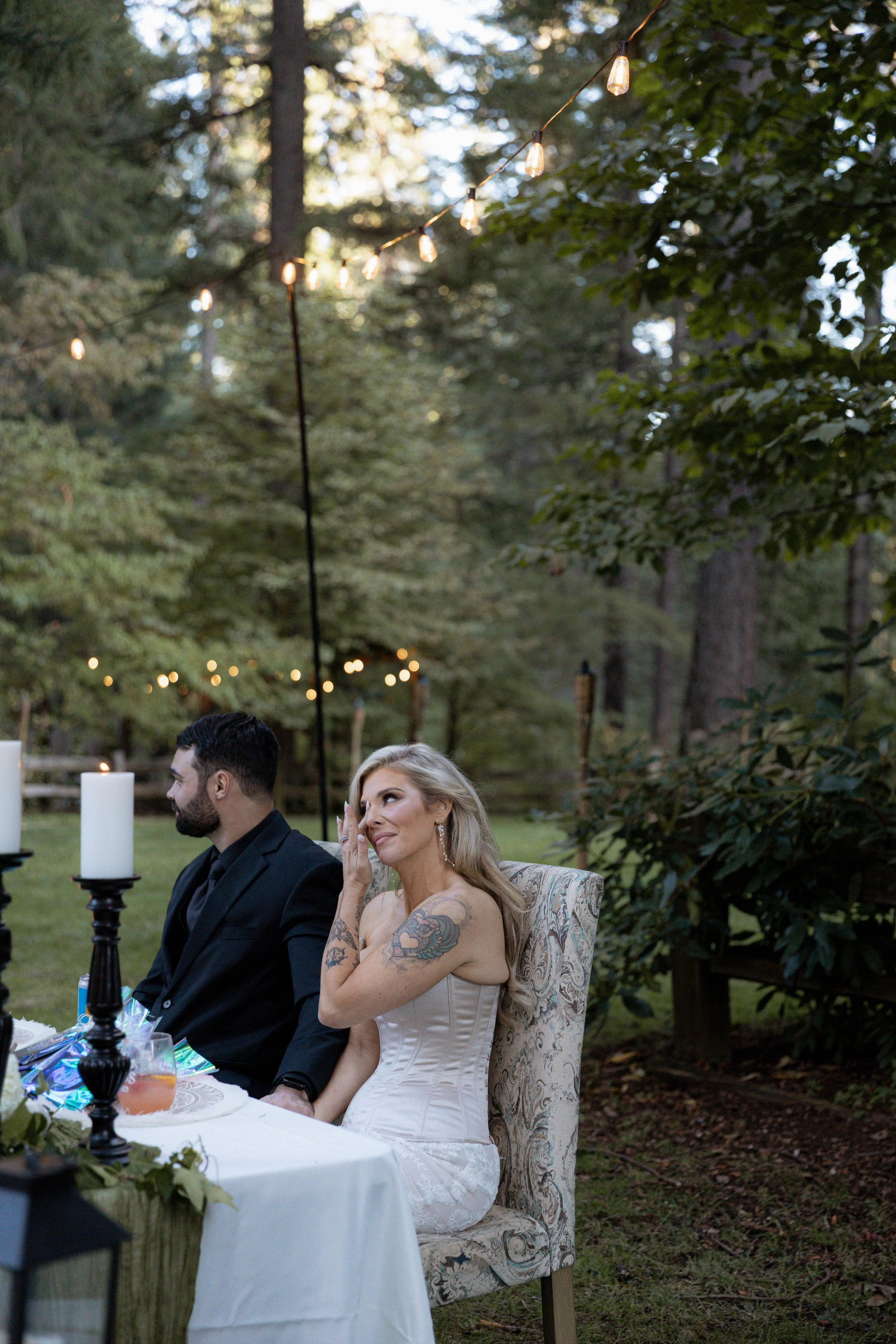 A bride and groom crying during wedding toasts