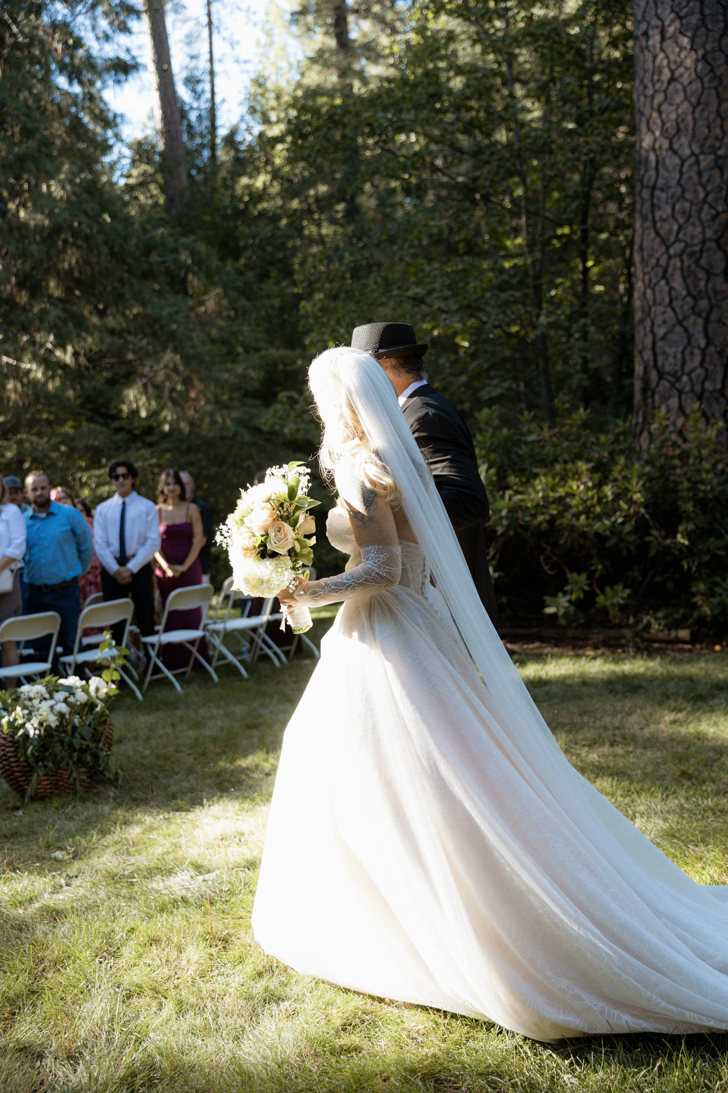 A bride having her dad walk her down the aisle at her California wedding venue
