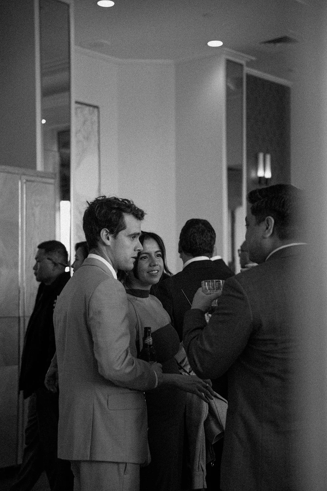 A candid photo in the cocktail hour section of the day of wedding timeline