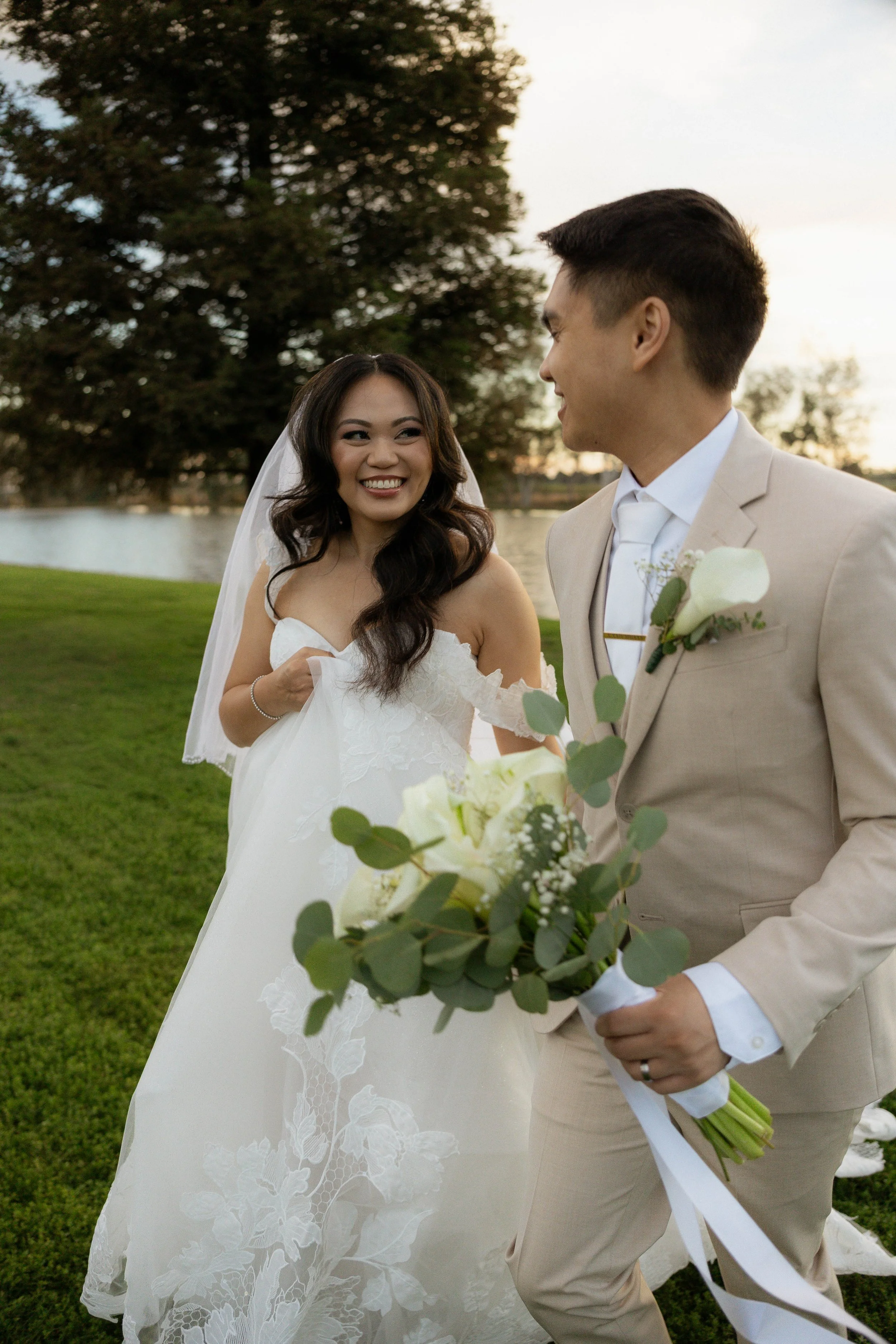  bride and groom frolicking at Lakeview estates during sunset 