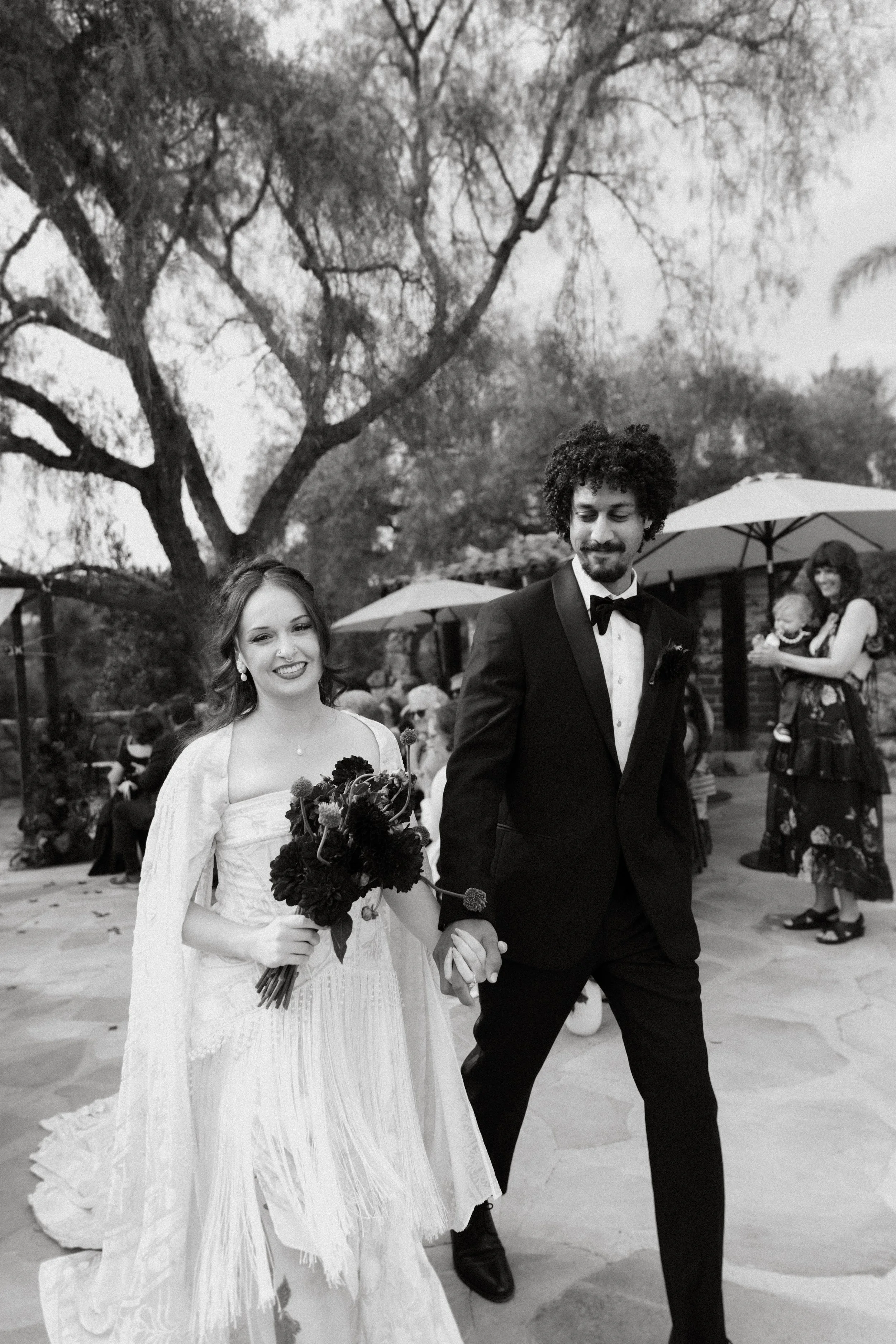 Bride and groom exciting their wedding ceremony as happy as can be