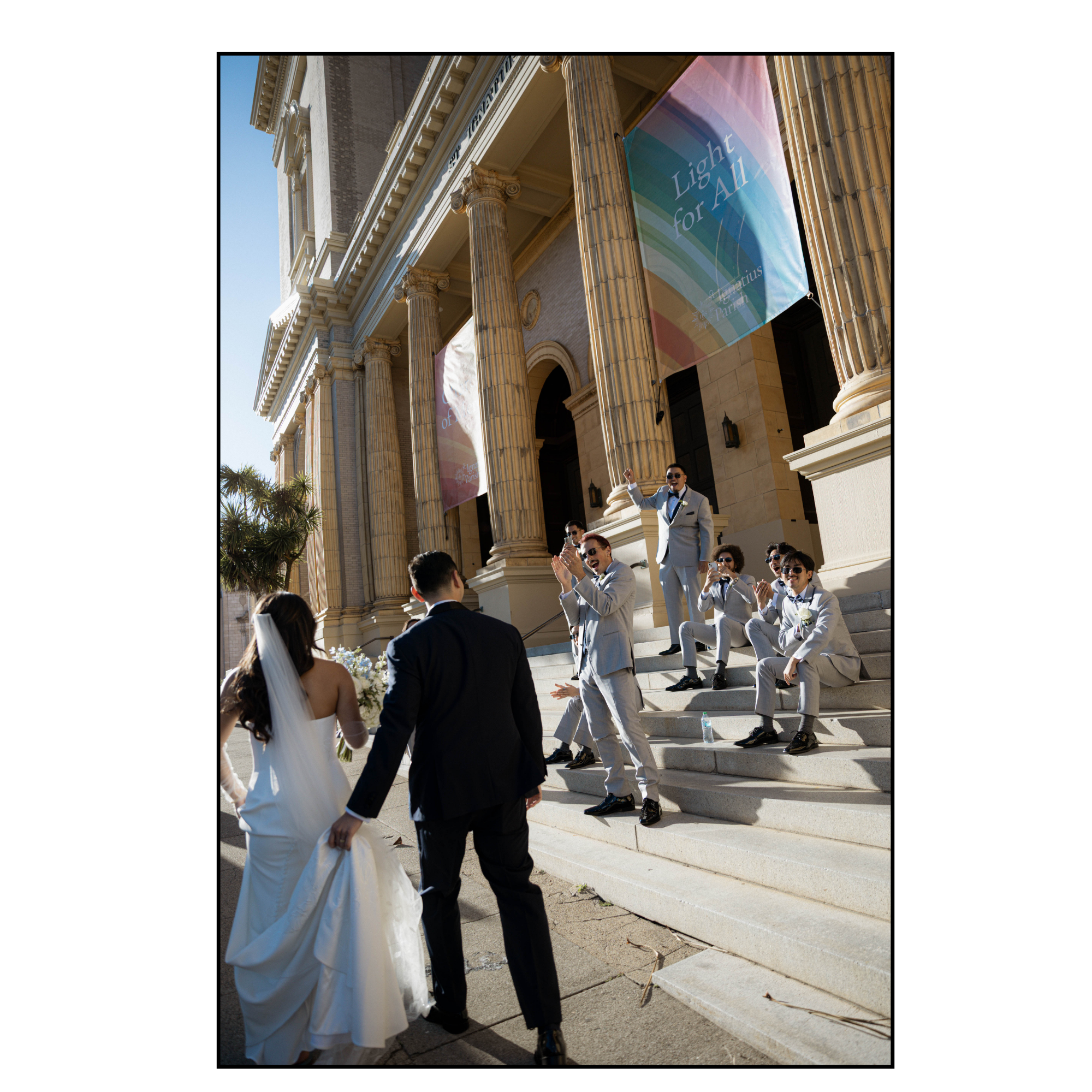 Sacramento Wedding Photographer Grand Island Mansion Wedding Photographer NorCal Wedding Photographer bride and groom reaching for each others hand Groomsmen cheering bride and groom on after ceremony