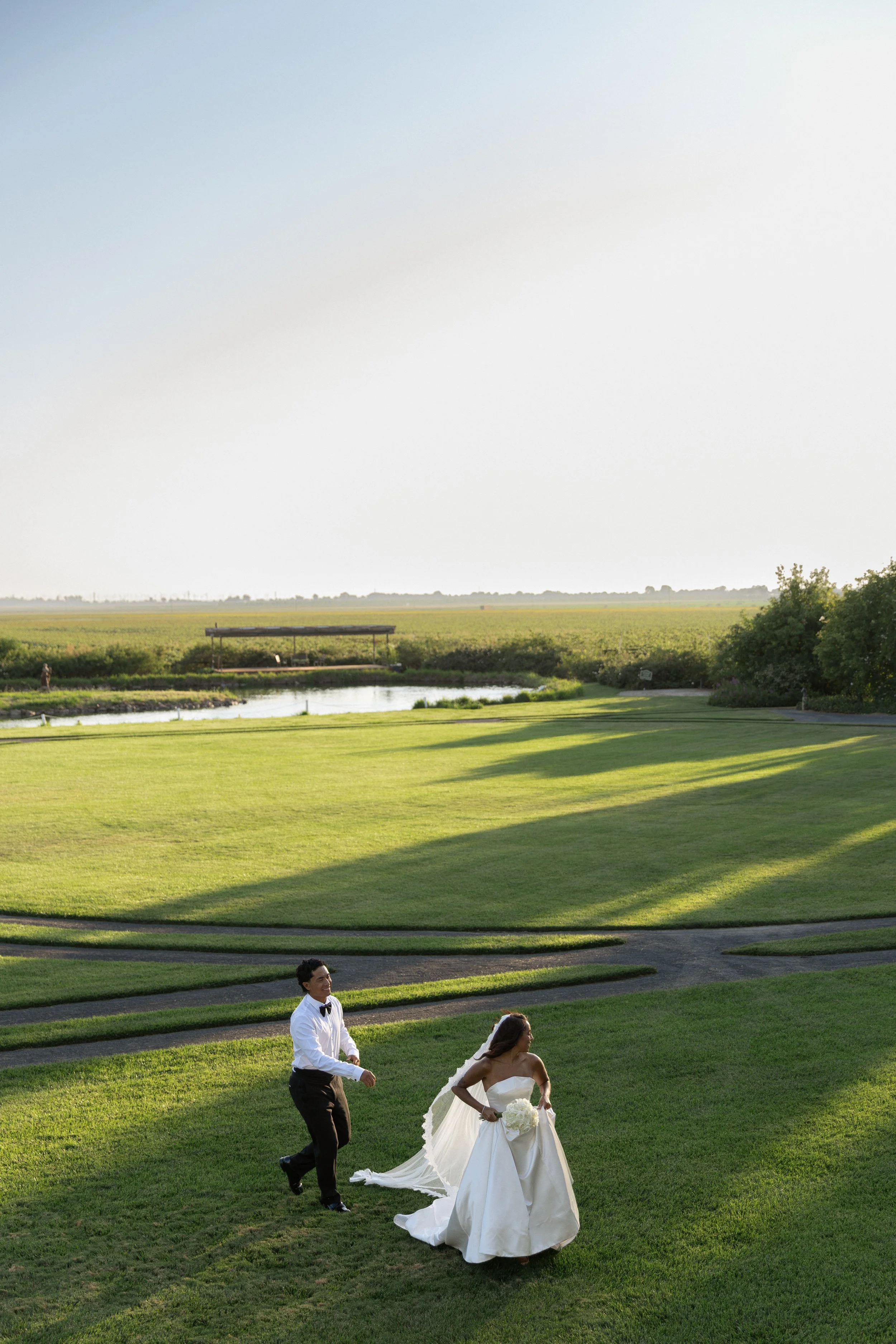 bride and groom chasing each other in front of cavaignac estate