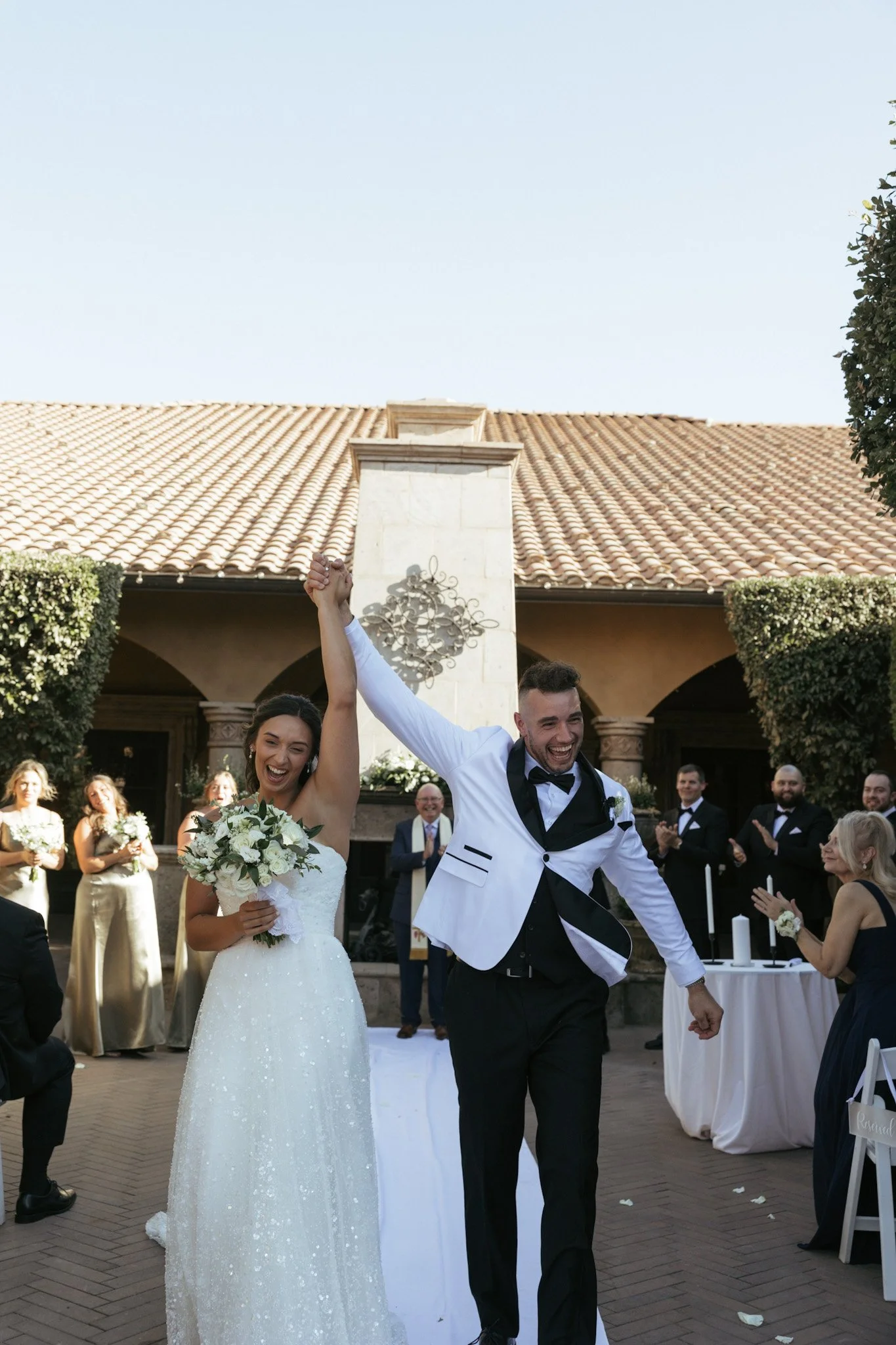 bride and groom exiting their ceremony happy to be newly weds at the villa Sienna wedding venue