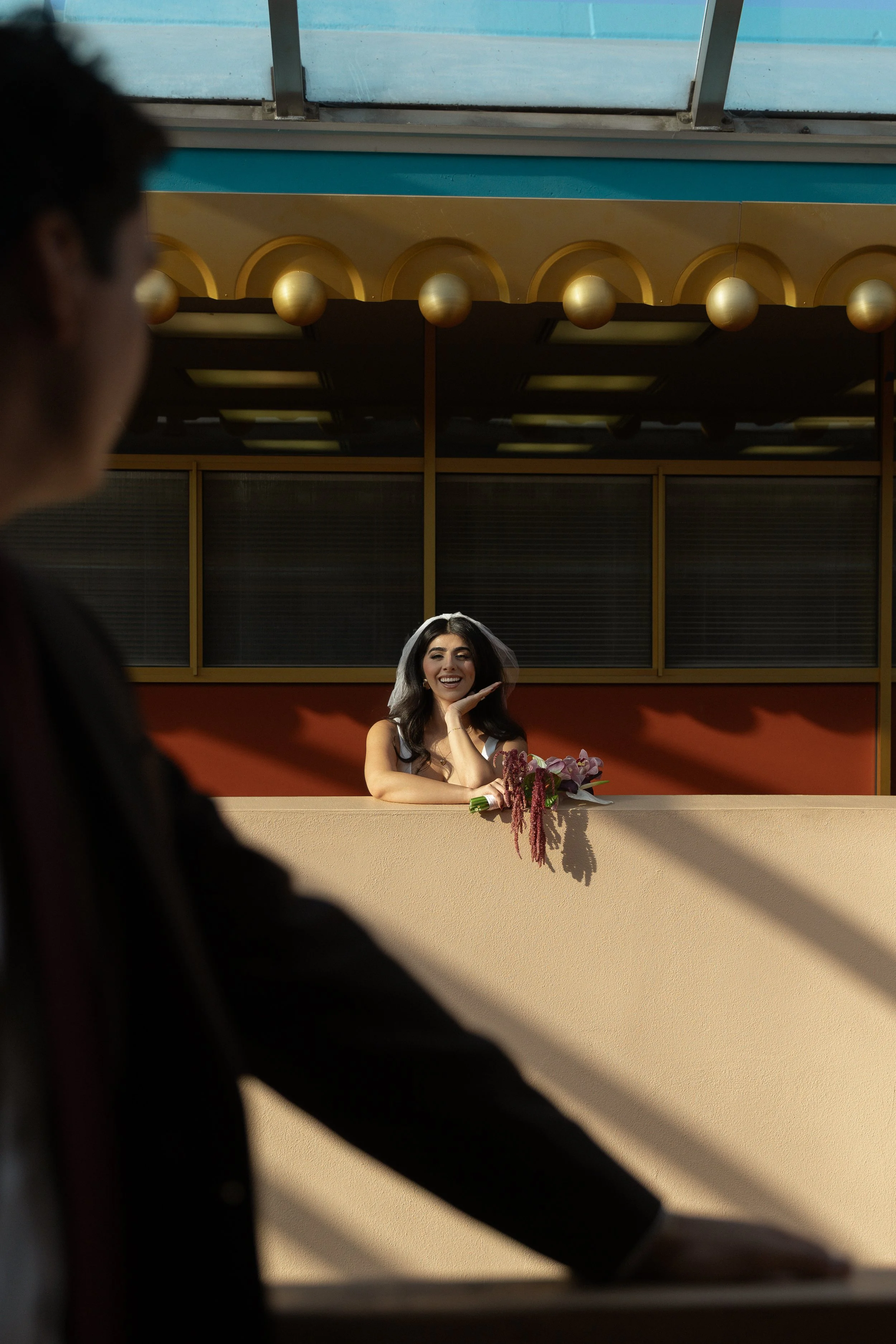 man looking over his shoulder at his fiancé in awe as she smiles at him
