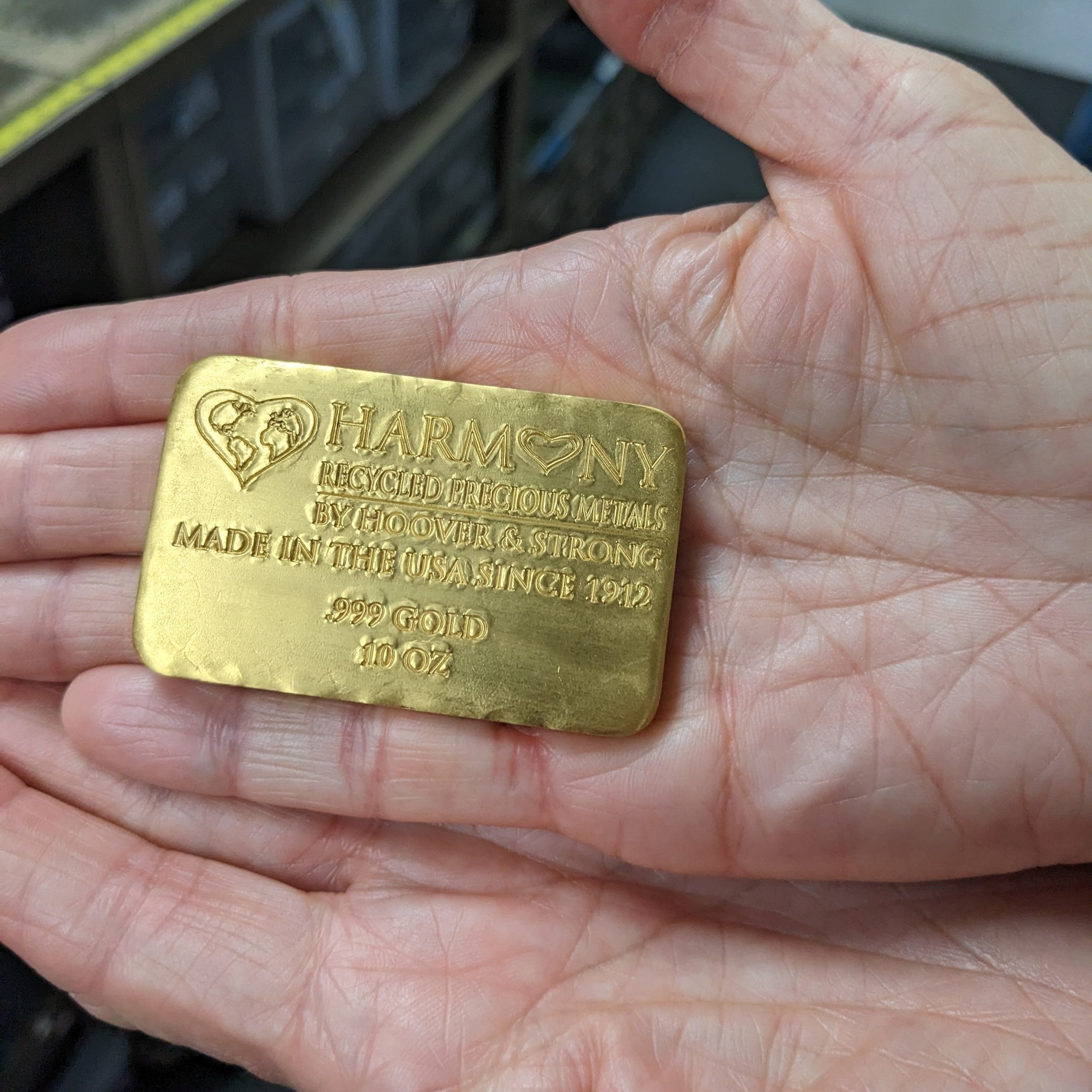  EM Members visit Hoover &amp; Strong metal refinery. Shown is an ingot of their line of Harmony gold.