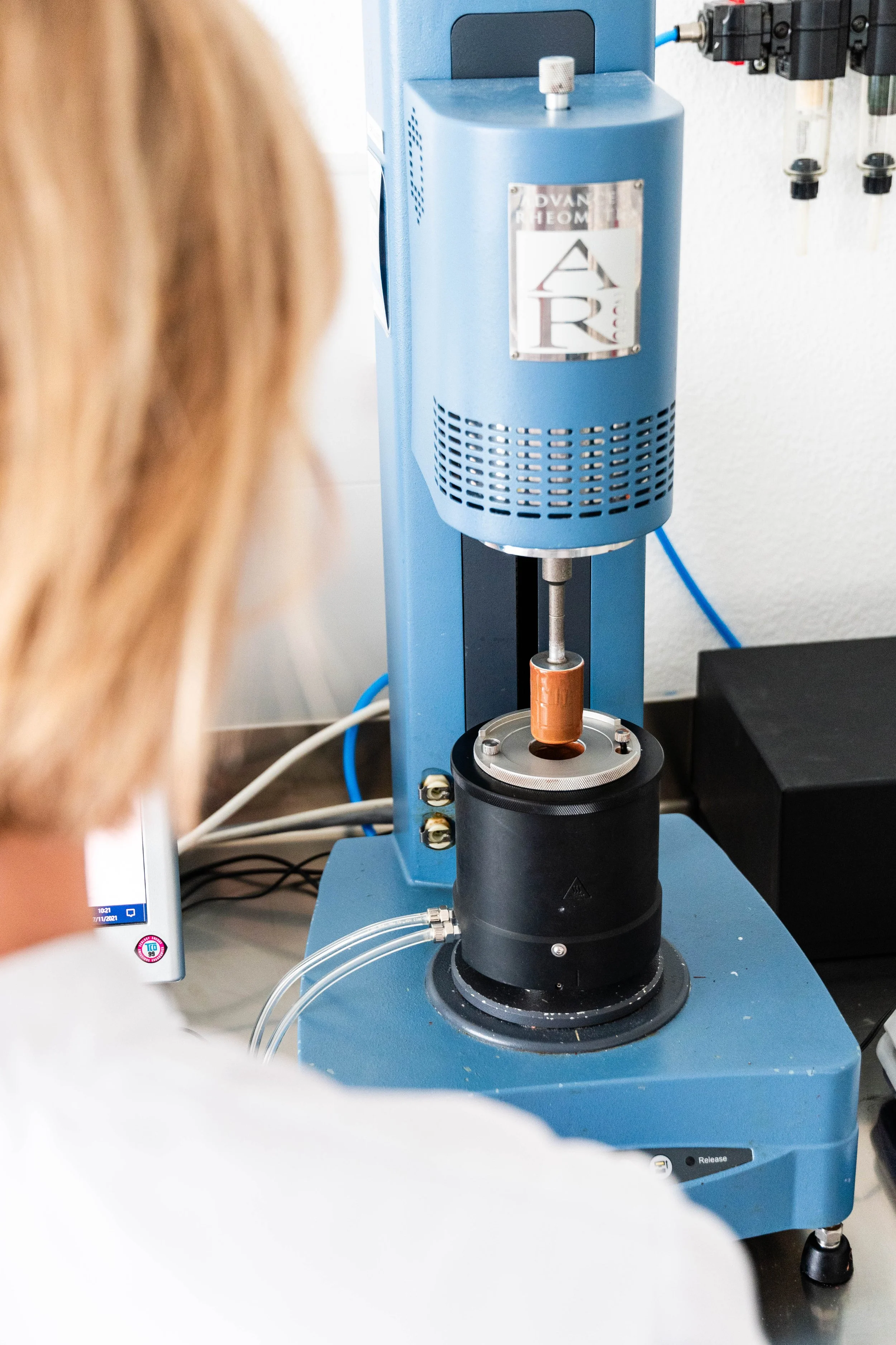 Person operating a rheometer in a laboratory setting