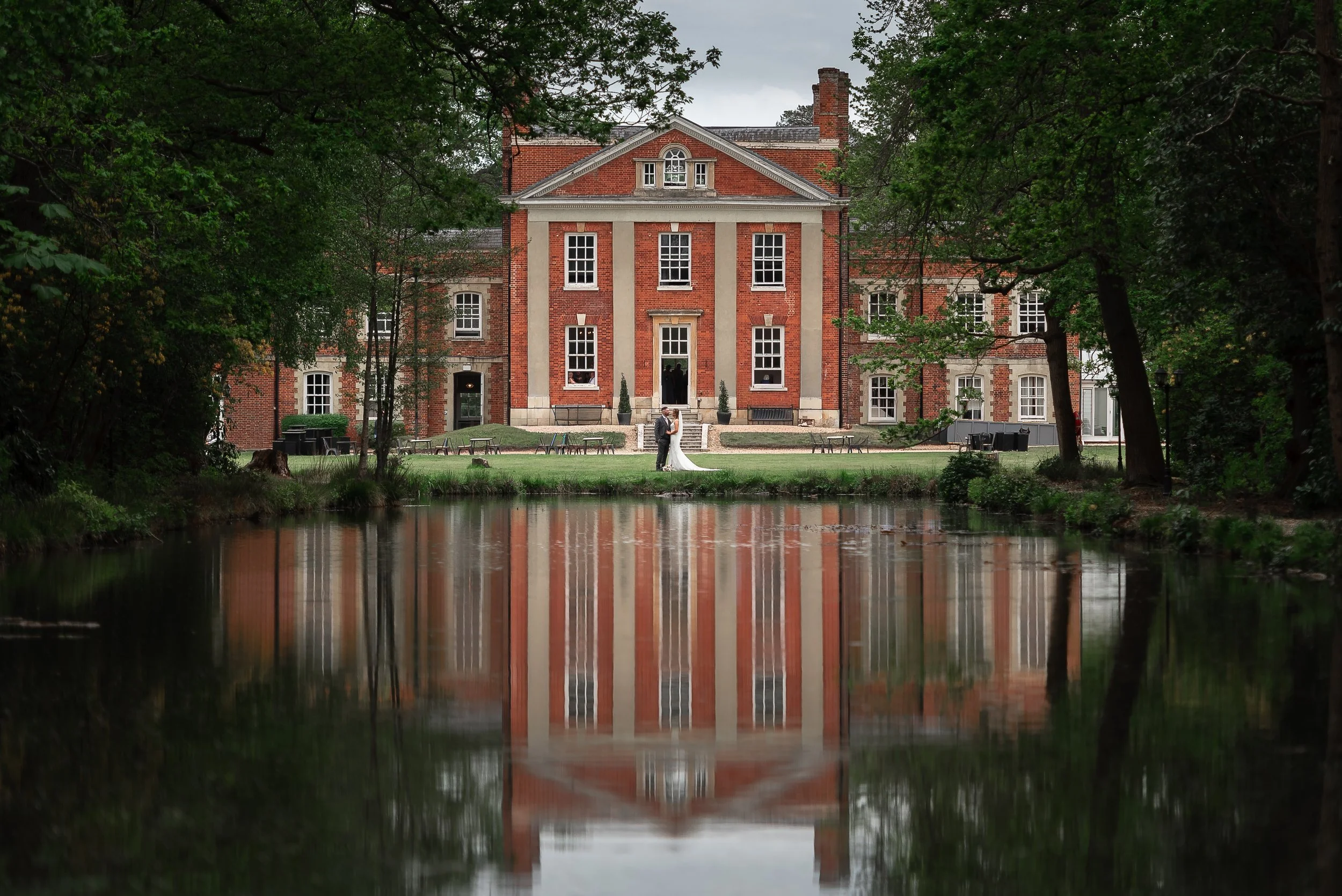 The beautiful lake view at a Warbrook House Hotel wedding with the bride and grooms subtle reflection engulfed in the prestigious Warbrook House reflection