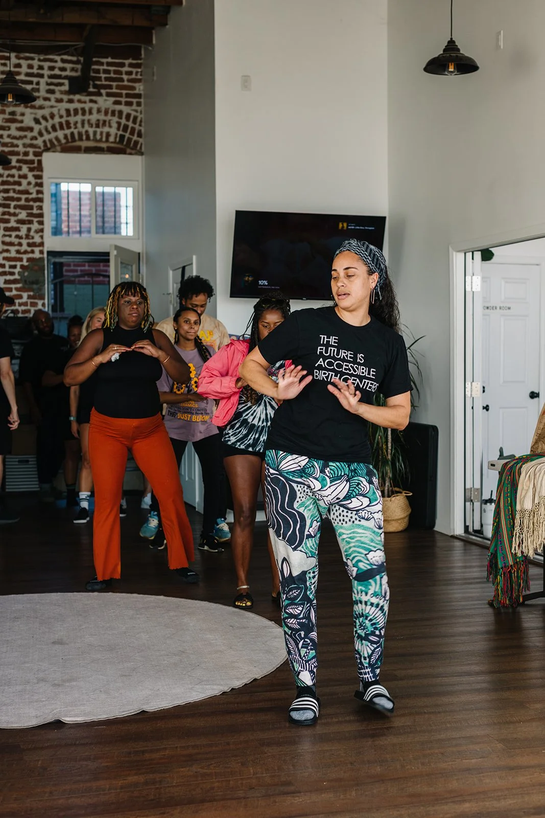 group of expecting mothers are led in dance