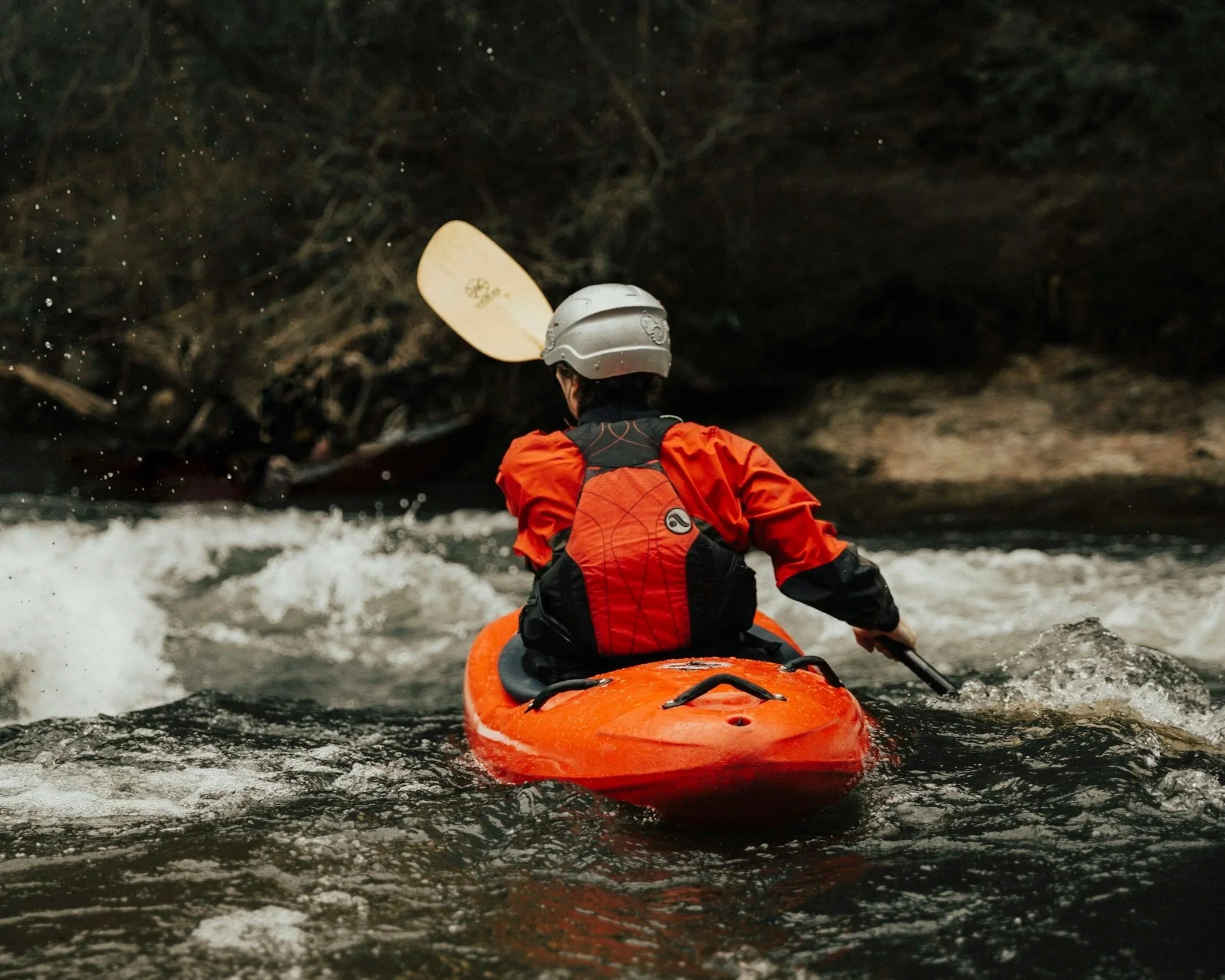 Person navigating Adirondack whitewater in a Kayak.