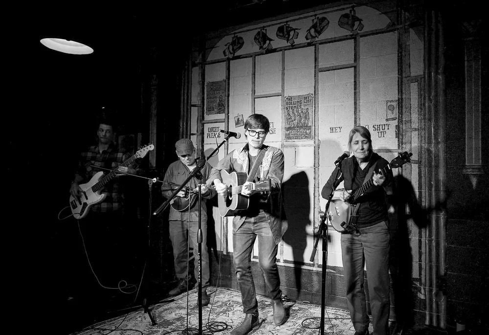 Black and white photo of Slough Creek performing live in concert.