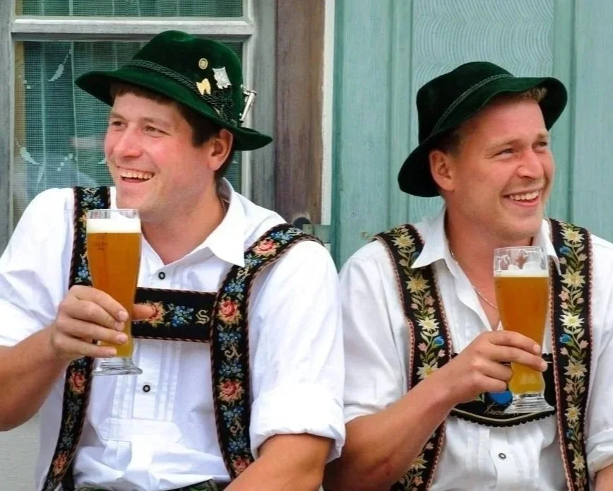 Men in lederhosen enjoying Old Forge's Oktoberfest in the Adirondacks.