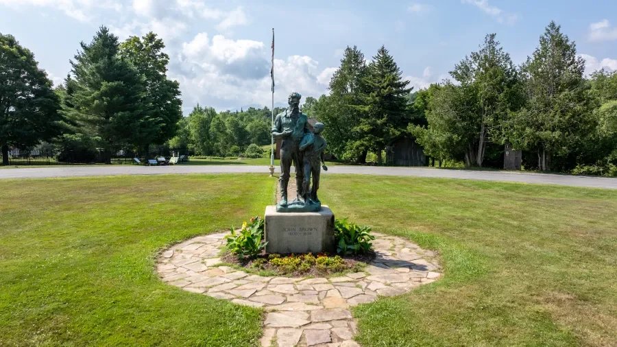 Statue of John Brown with young man.