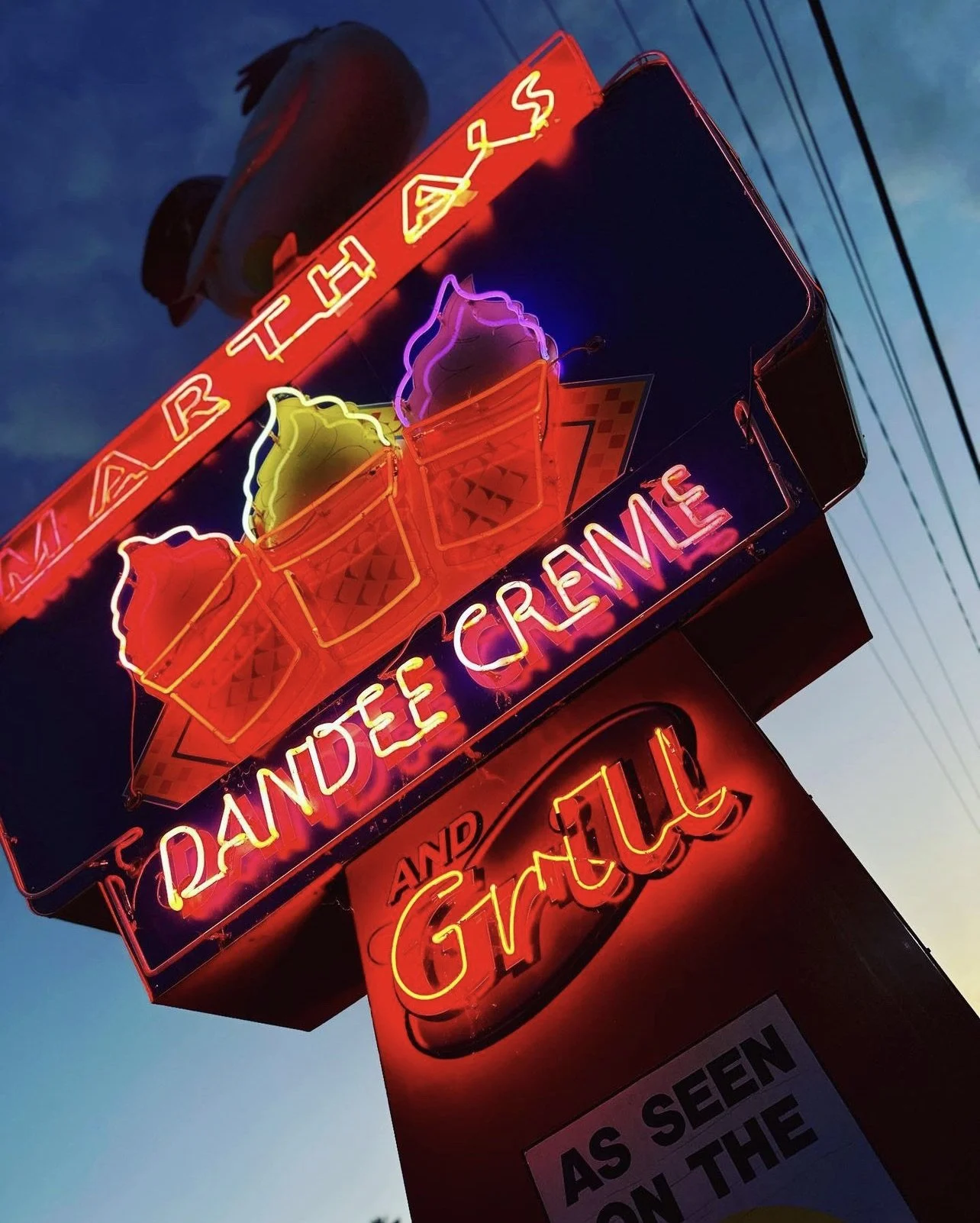 Neon sign for Martha's Dandee Creme and Grill in Lake George.