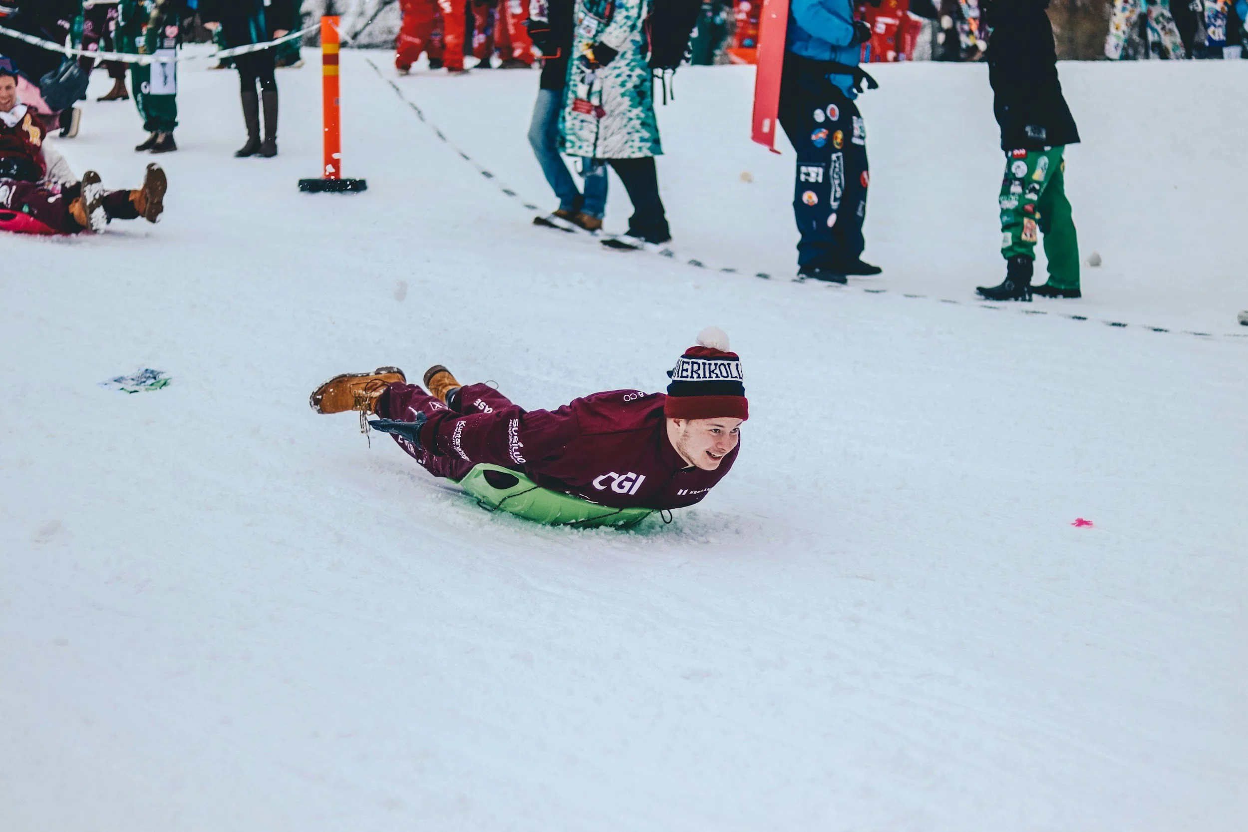 Kid's enjoying sledding at an Adirondack winter carnival.