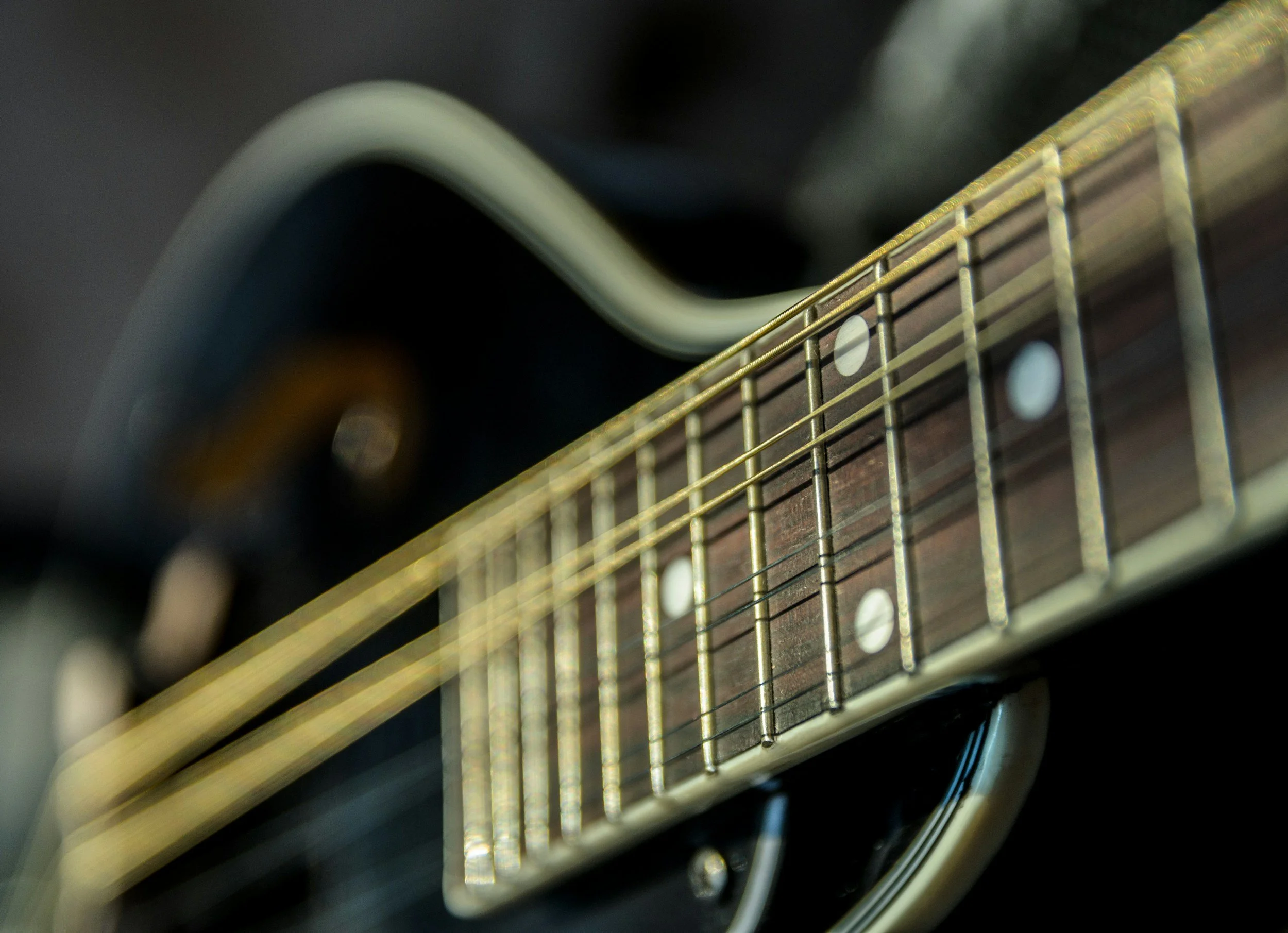 Image of a guitar, a frequent instrument in American Roots music.