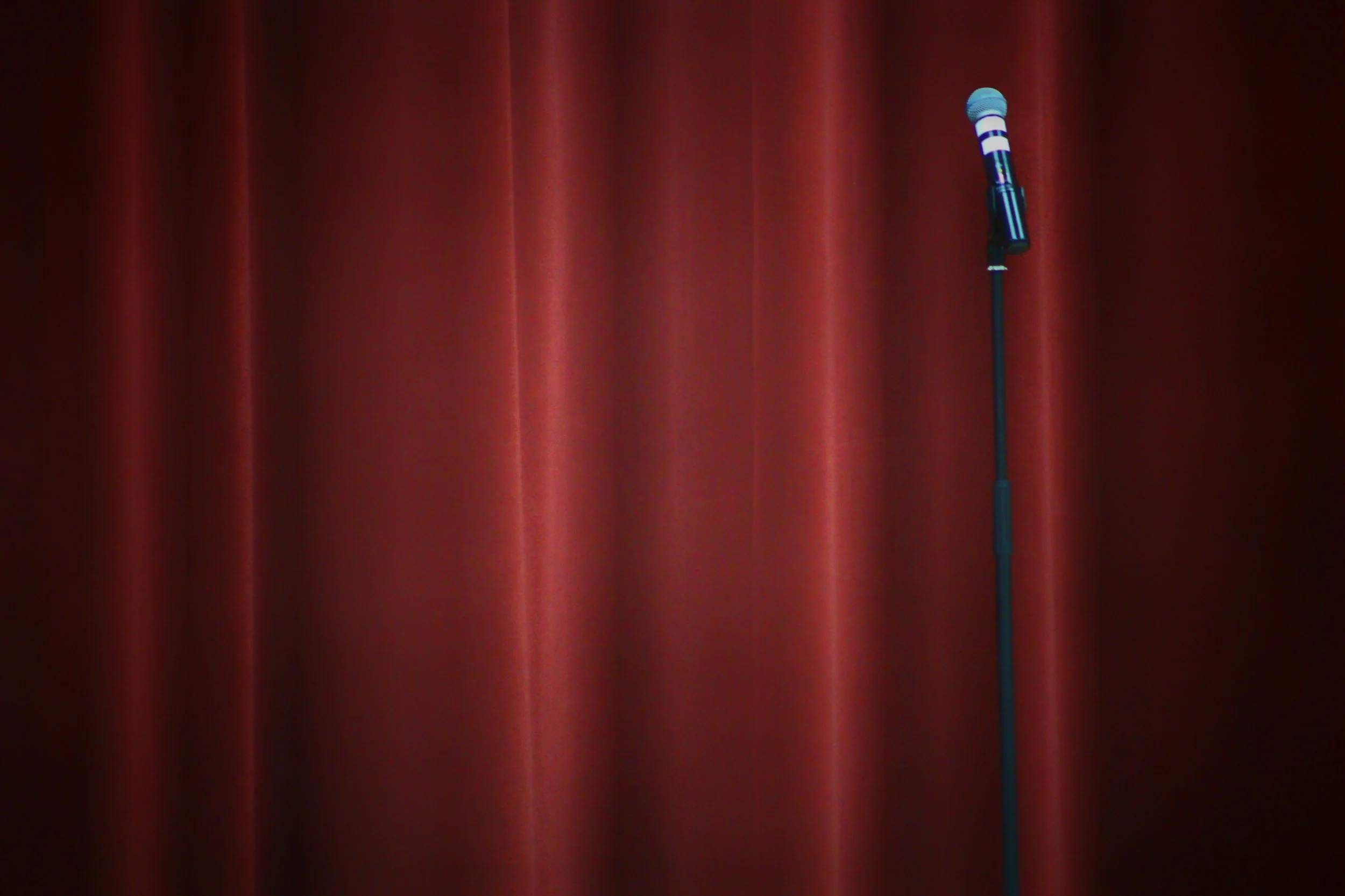 Comedy club stage with microphone for stand-up comic.