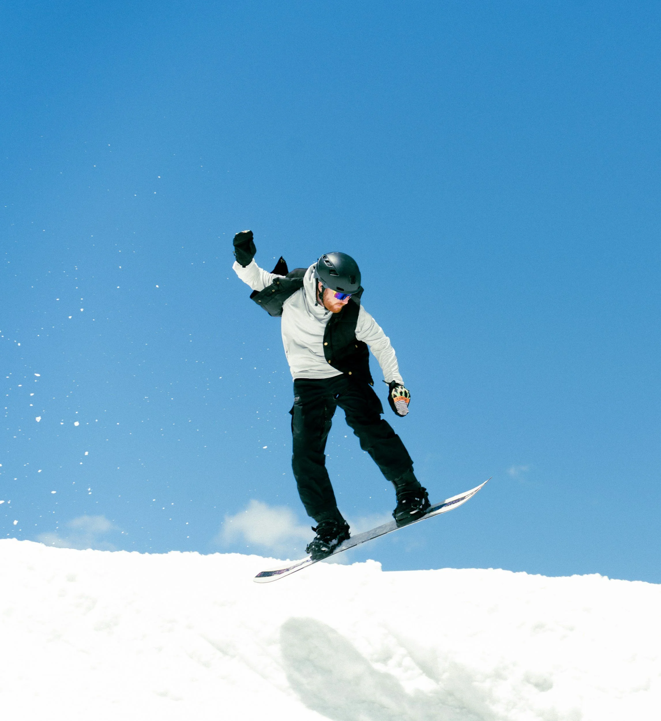 Snowboarder in spring at whiteface mountain near lake placid.
