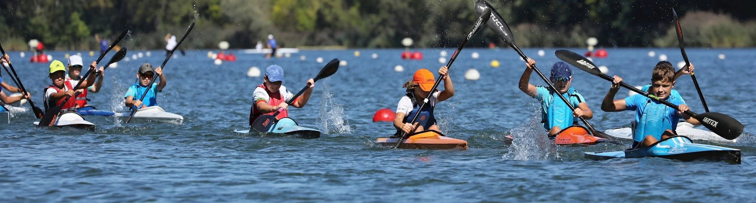 kayakers racing on an Adirondack lake.