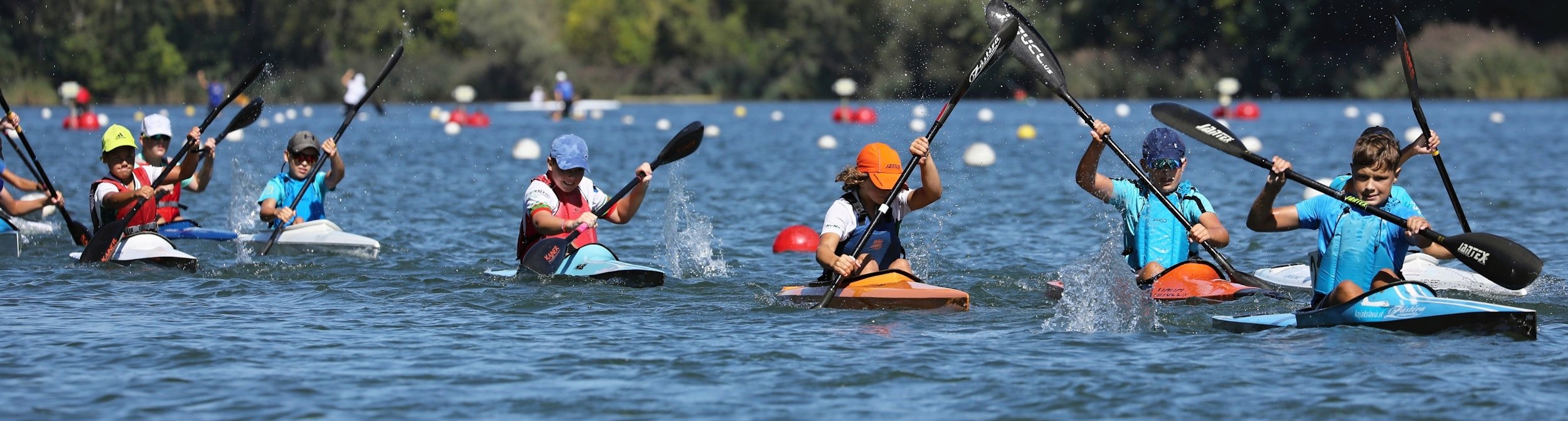 A group of kayakers racing on an Adirondack lake.