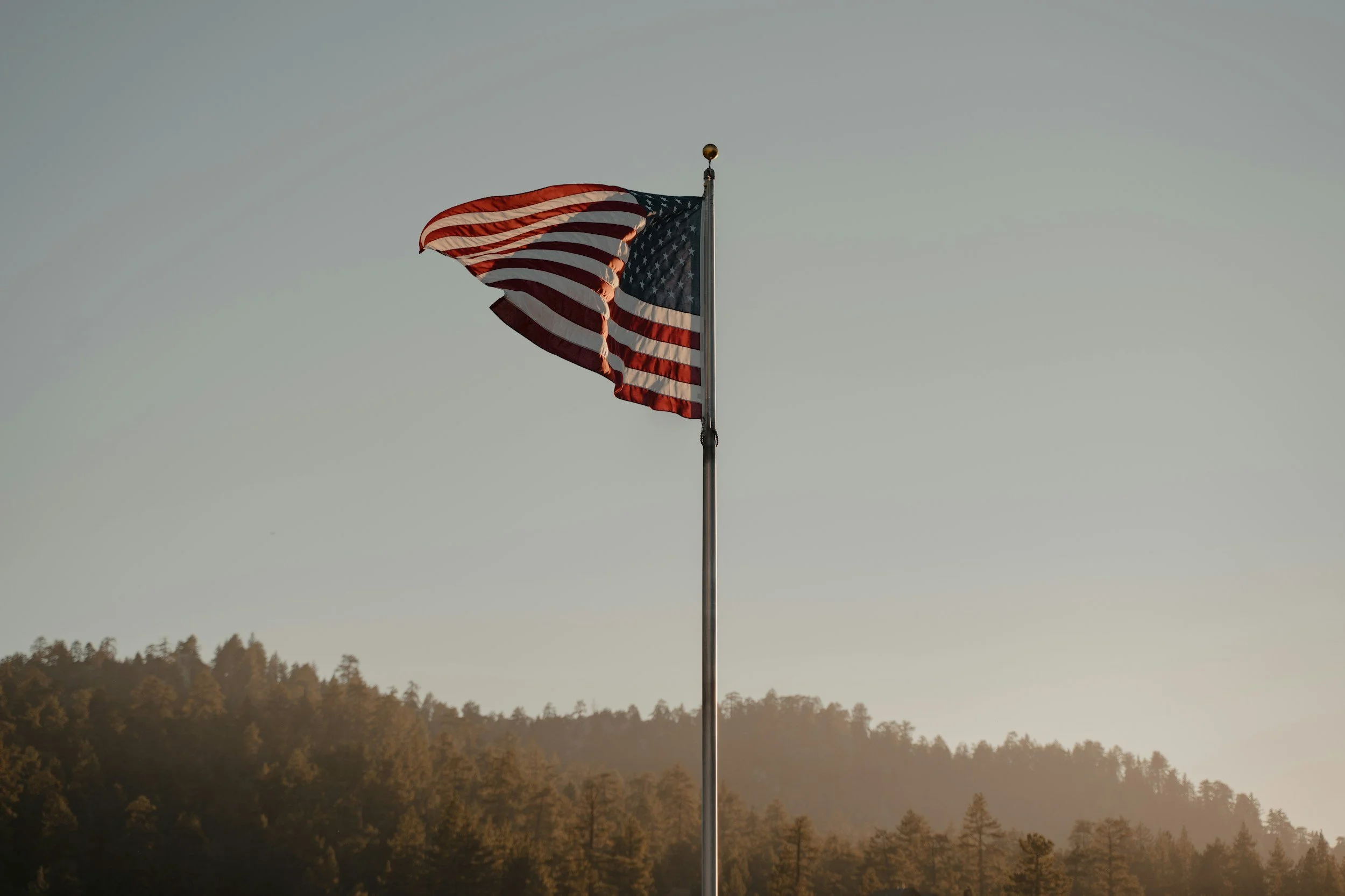 American Flag flying in the mountains.