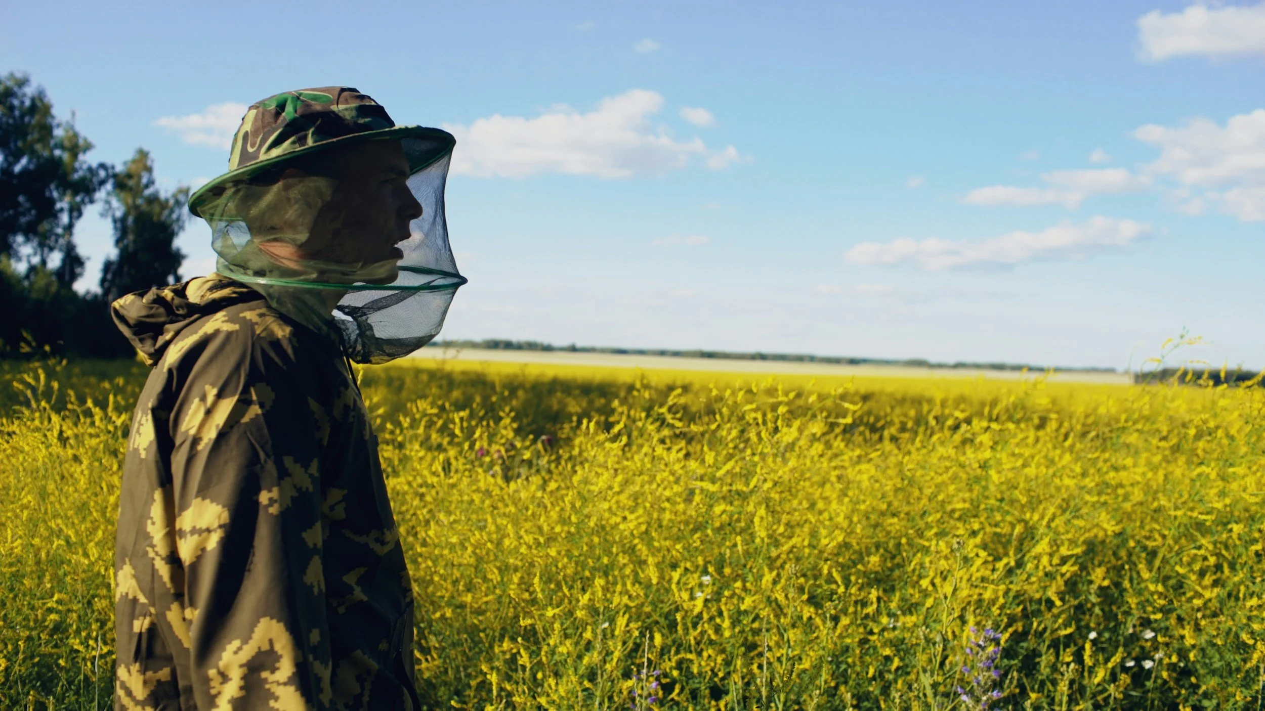 Man wearing a hat with black fly netting