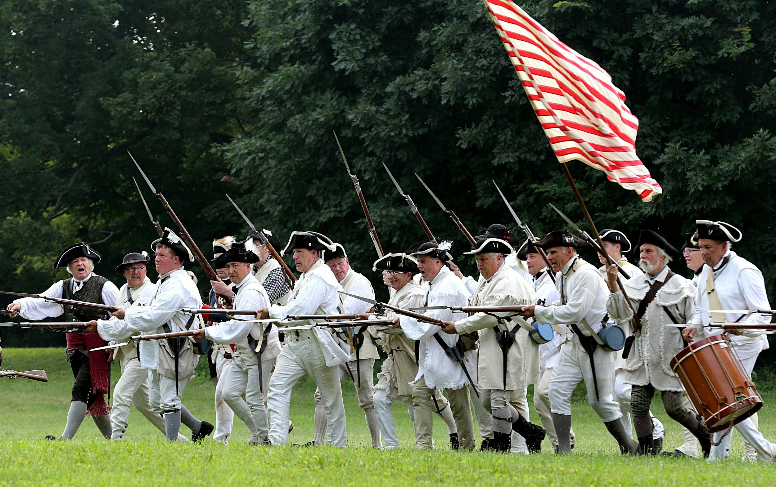 Men re-enacting a battle in the American Revolution.