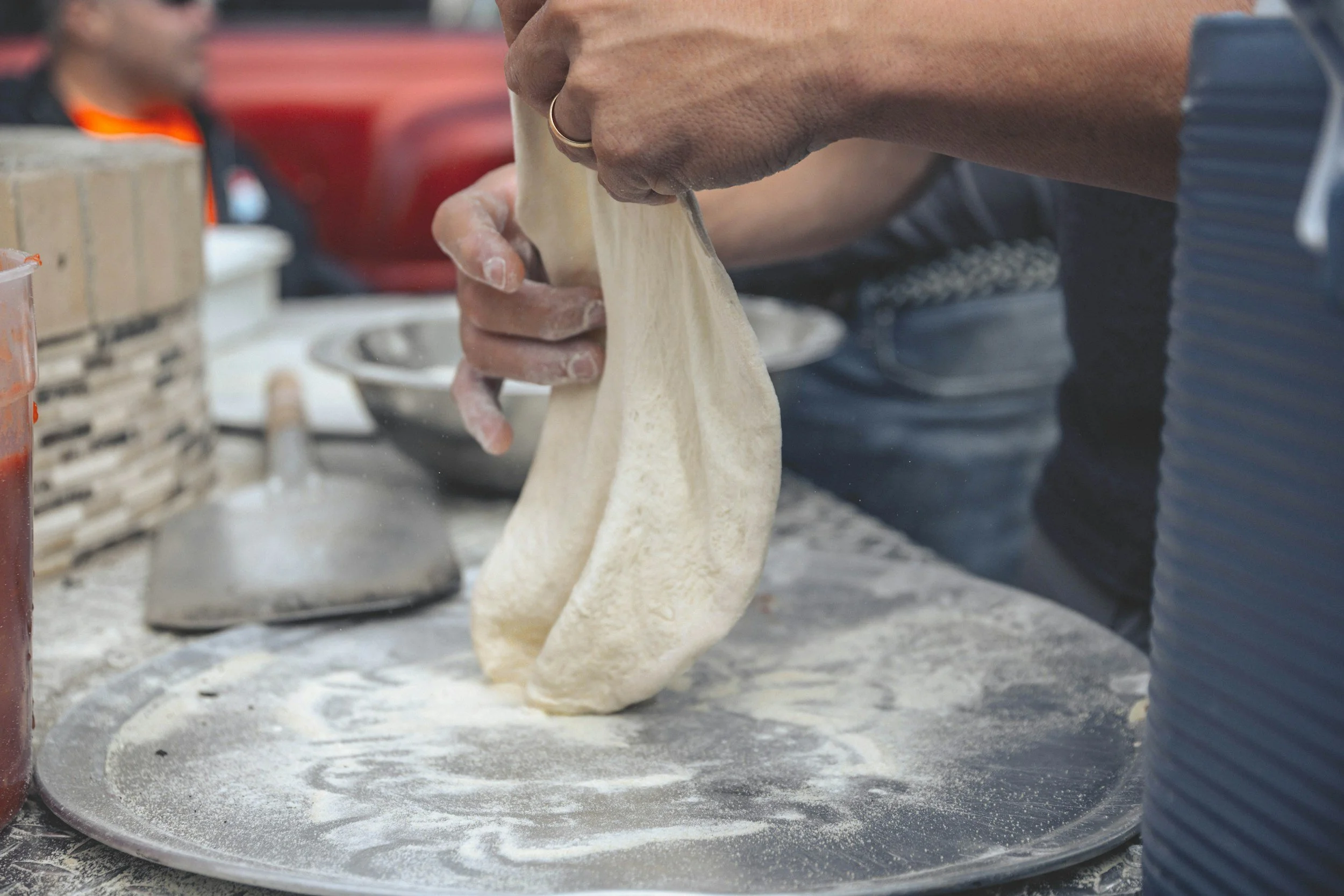 kneading pizza dough for the sweet treat, fried dough.